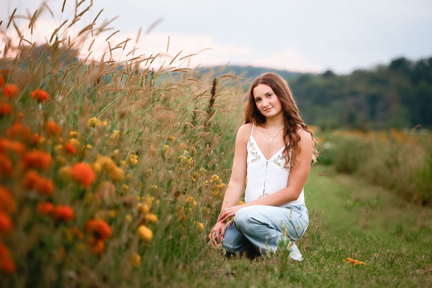Summer portrait in a wildflower field with orange poppies and tall grass.