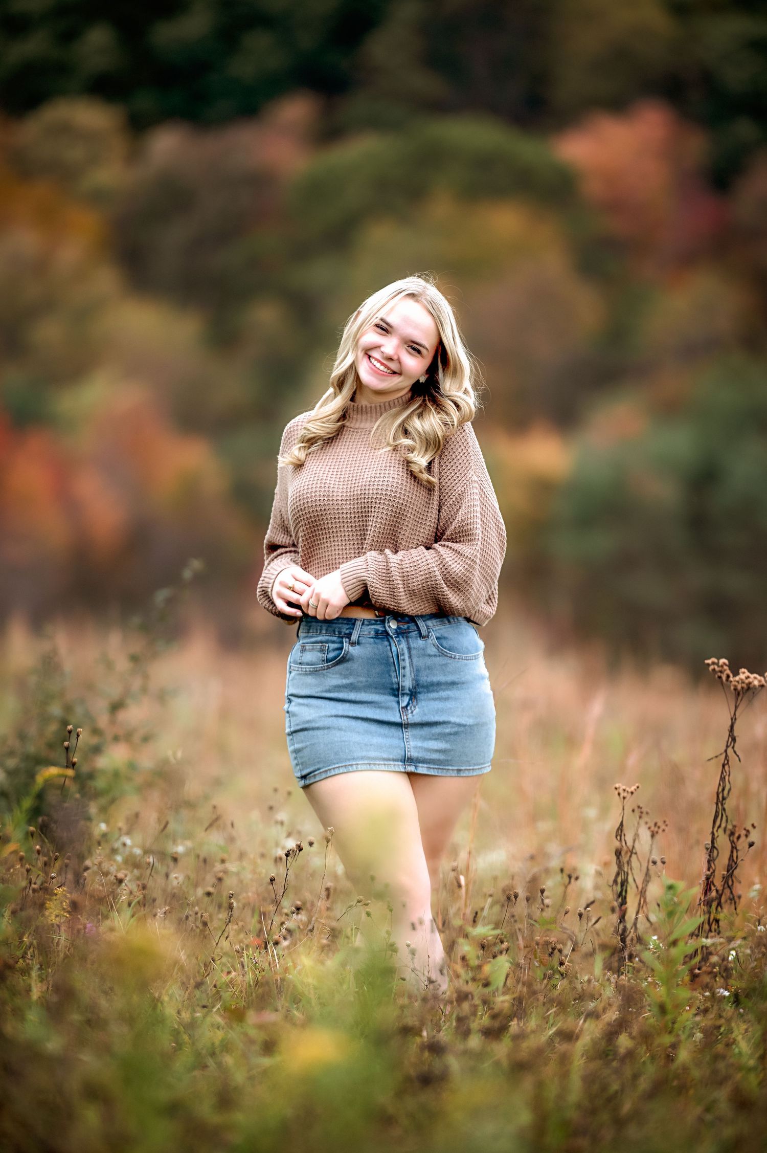 A dreamy outdoor photoshoot in a field with wildflowers and autumn colors.