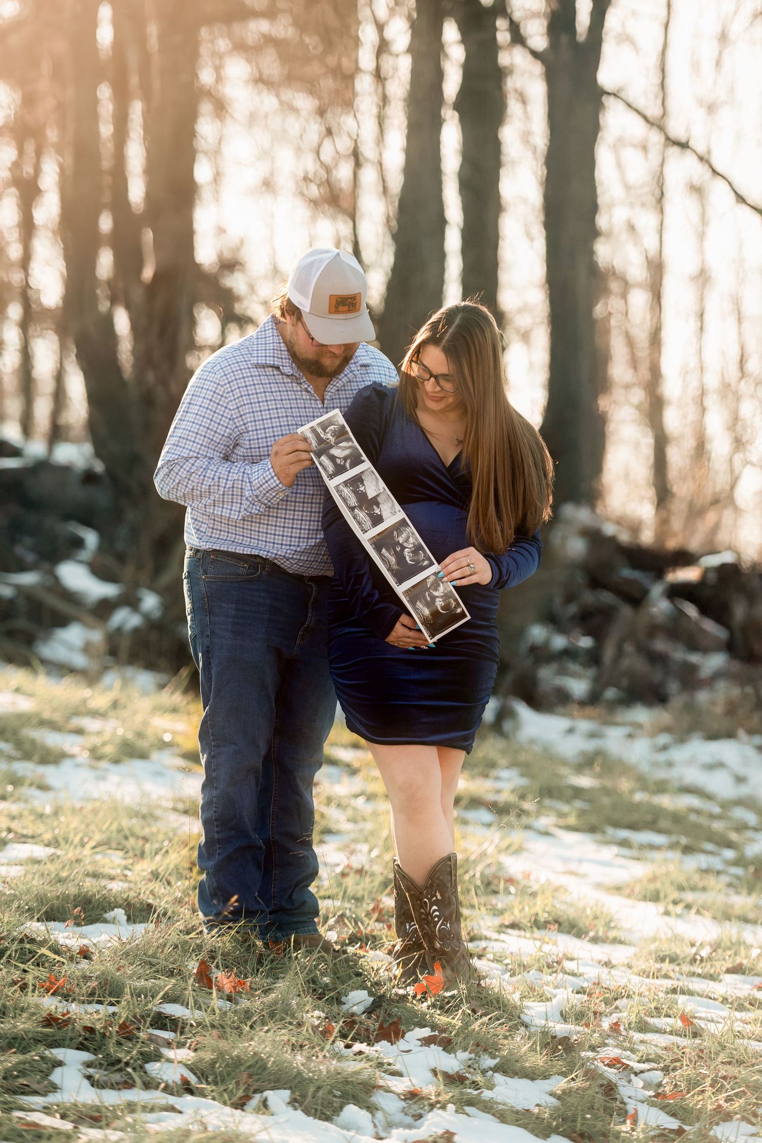 Winter maternity photoshoot in a snowy forest with ultrasound photos.