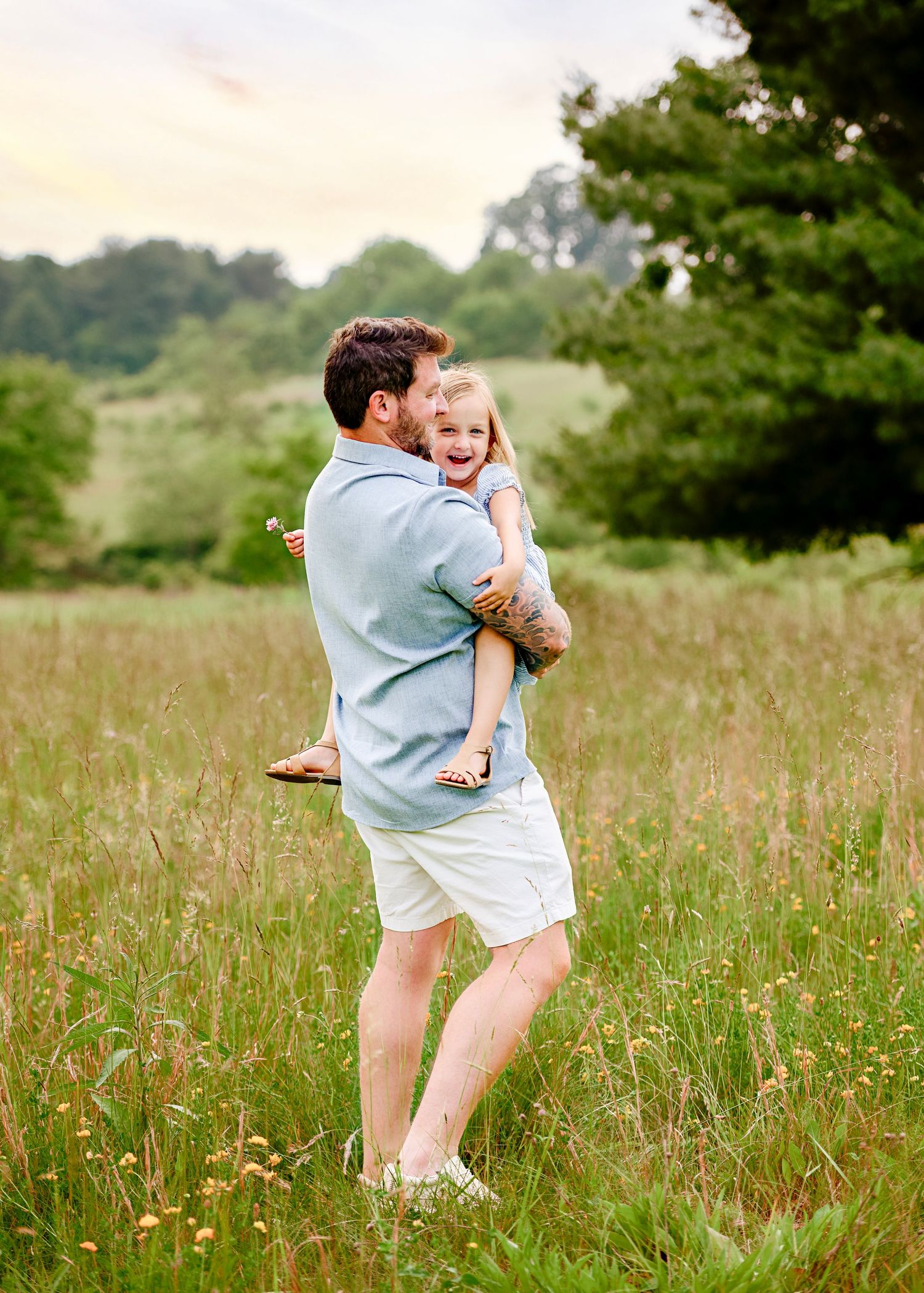 Playful interactions between family members in a sun-drenched meadow.
