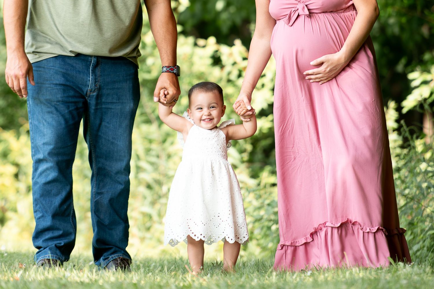 People wearing pink and green outfits walking together outdoors.