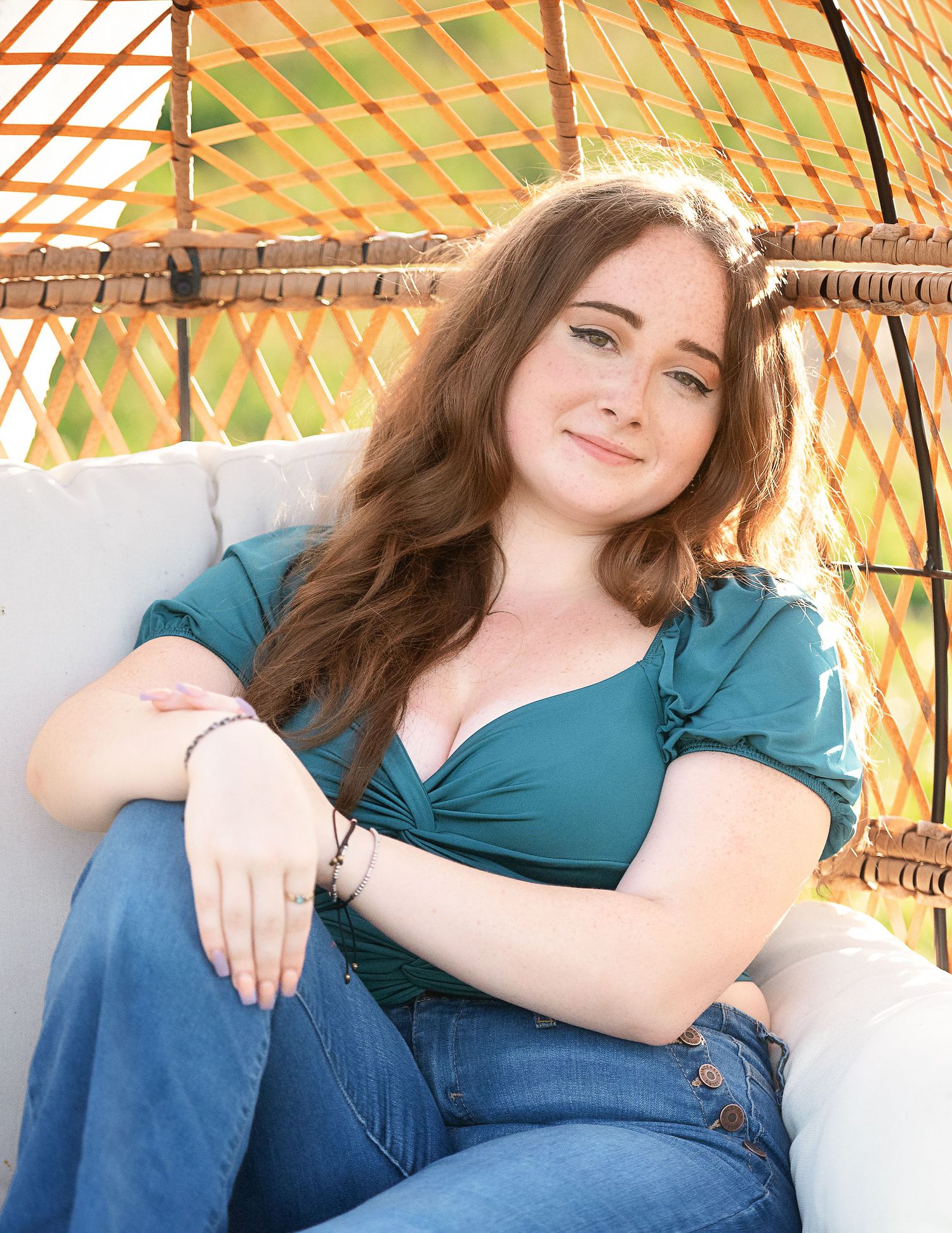 Relaxed poses on a white couch under an orange-tinted pergola.