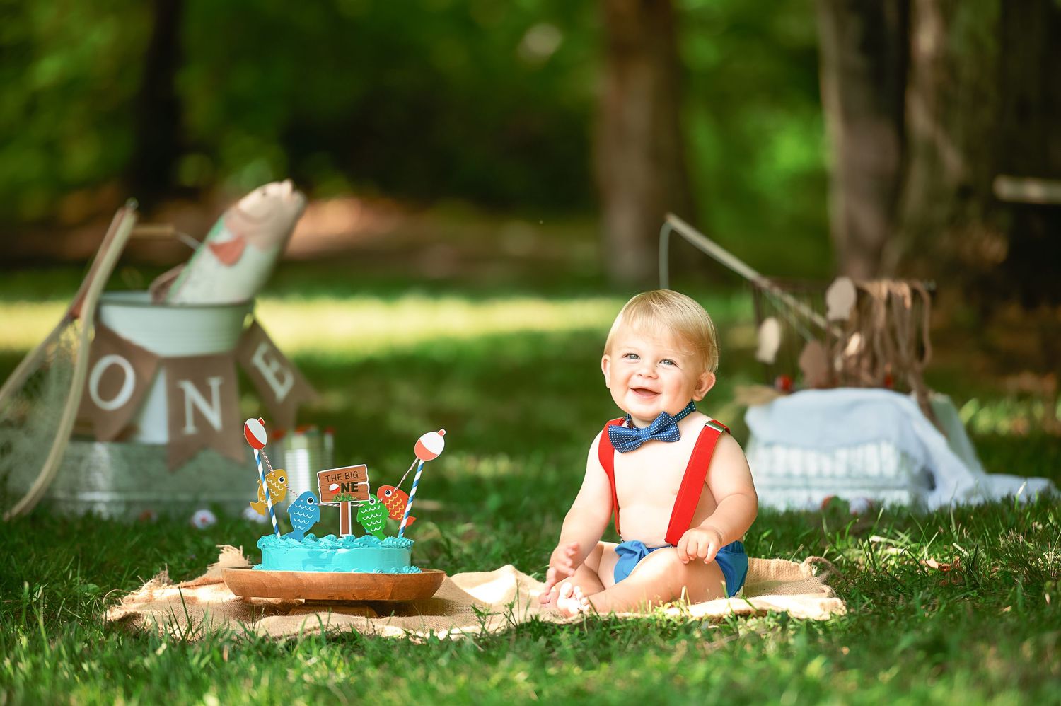Outdoor photography session in a grassy field with natural sunlight.