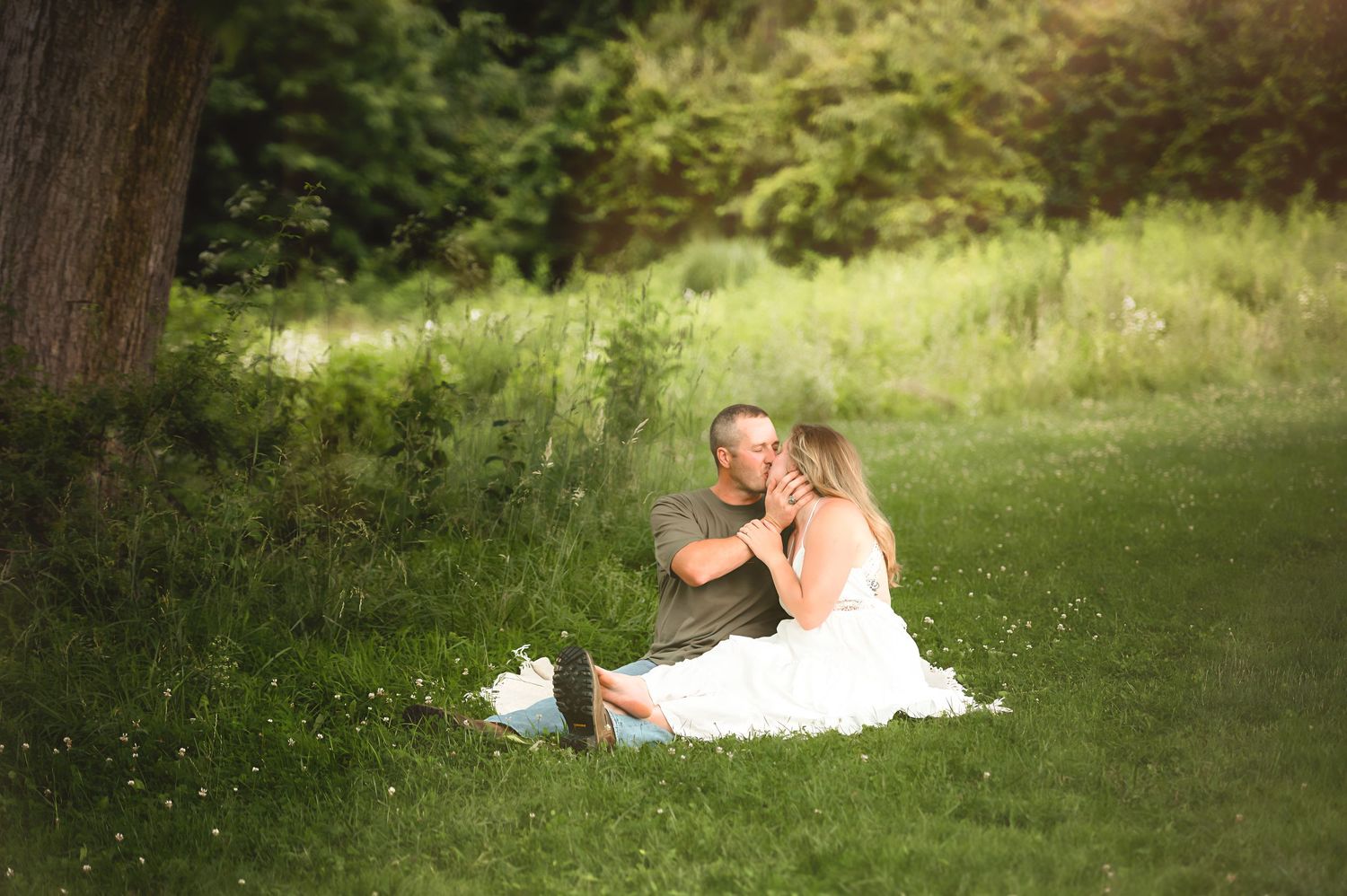 Couple enjoying a romantic afternoon in a lush summer meadow.