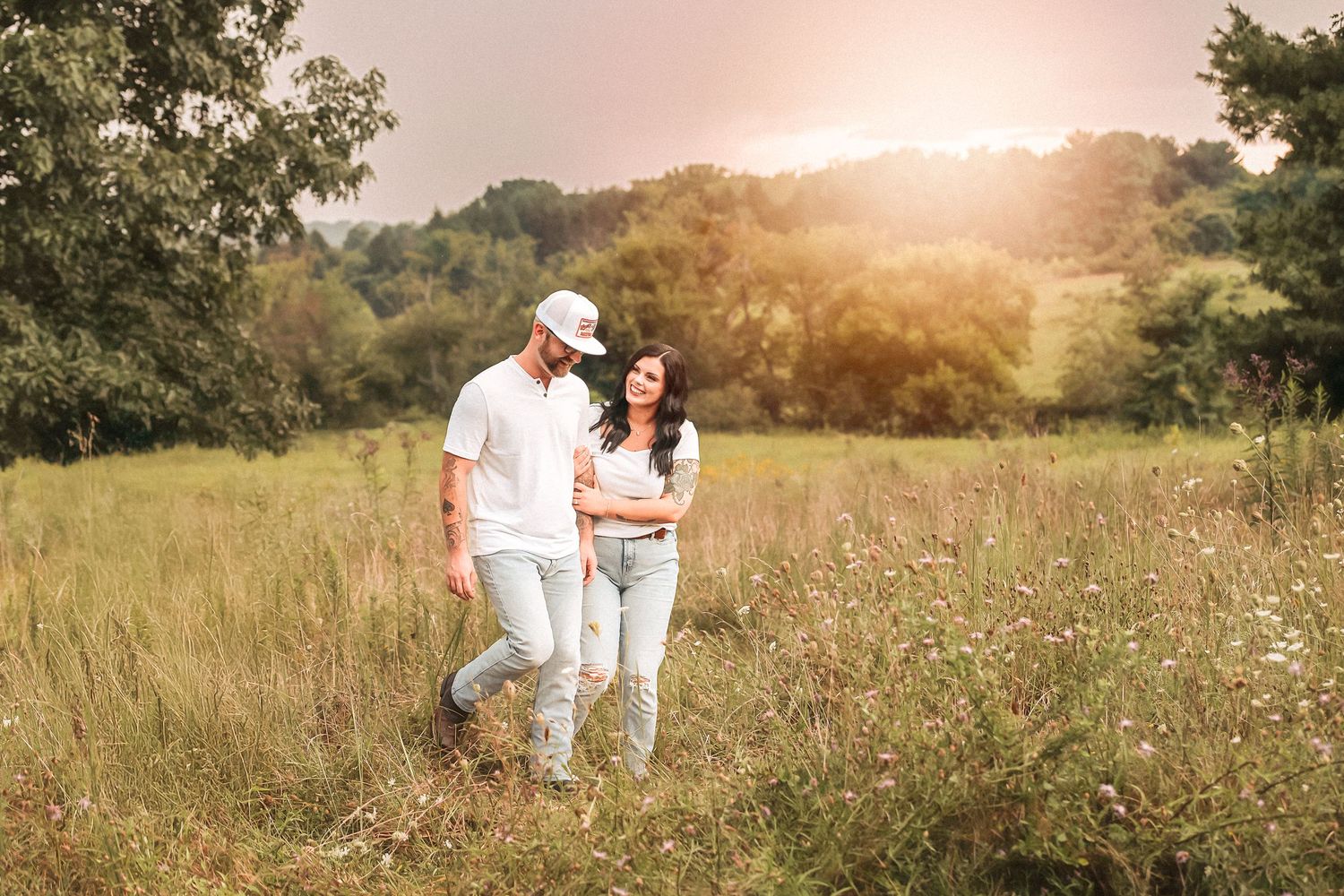 Romantic outdoor photo session in a rustic meadow at golden hour.