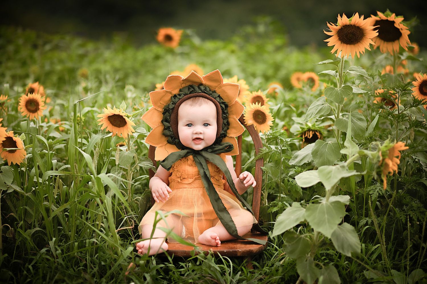 A small figure in an orange outfit sits among tall blooming sunflowers in a lush green garden setting.