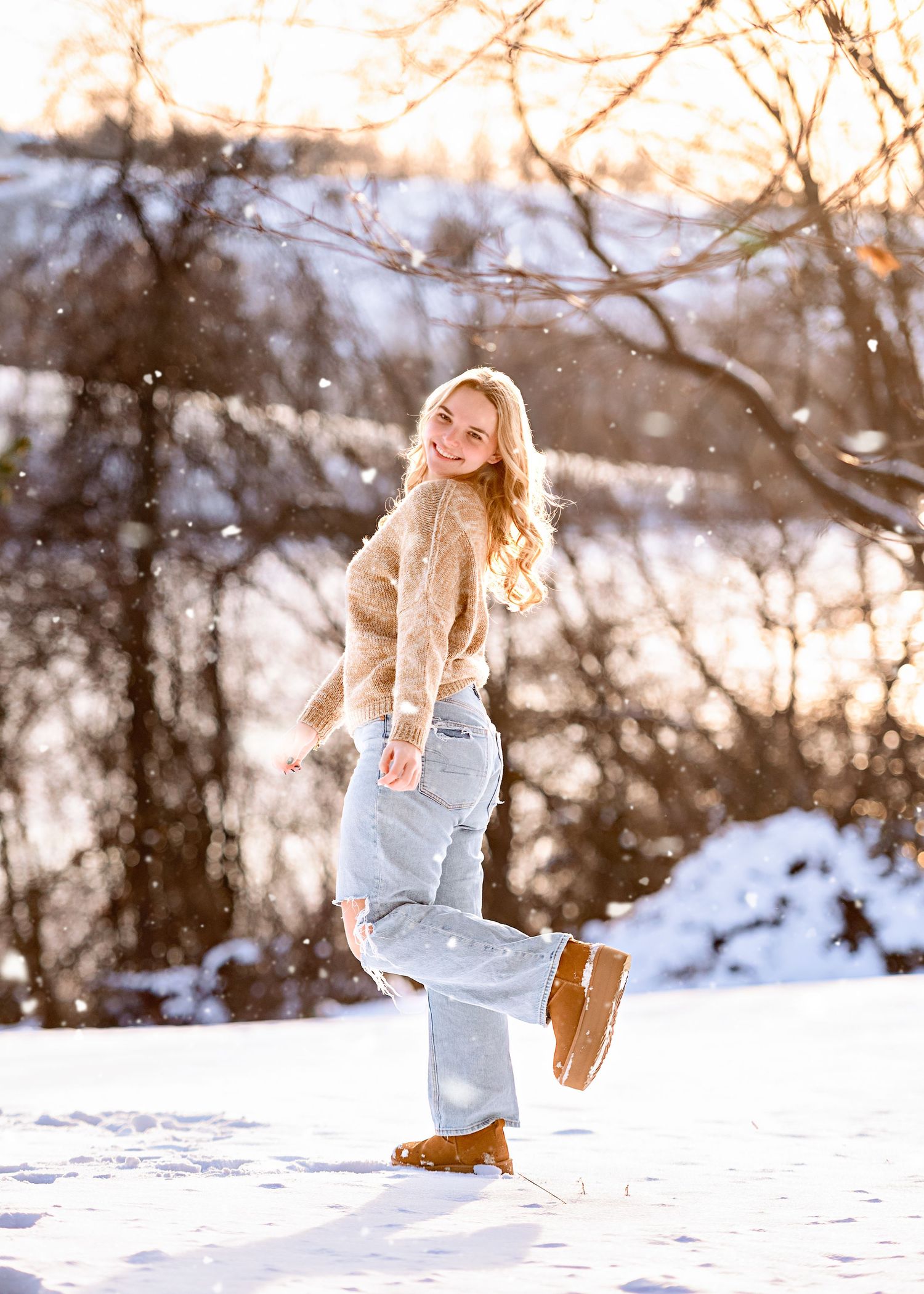 A playful winter photoshoot in the snow with cozy winter attire.