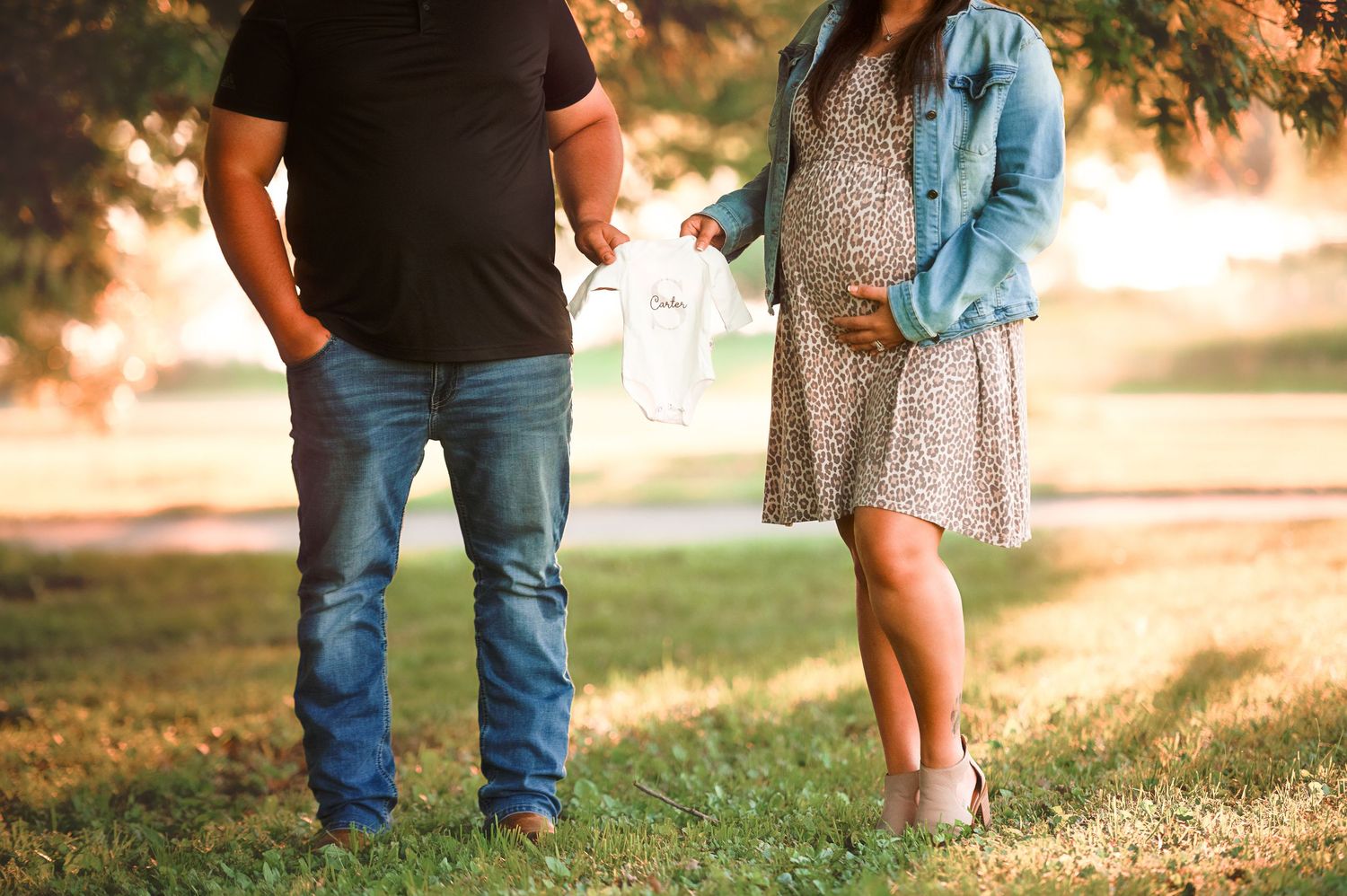 Casual couple walking together during golden hour in a park setting.