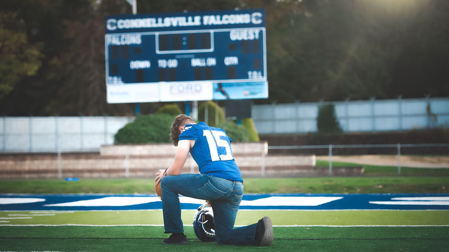 Football scoreboard and field visible during a game at Campbellsville stadium.