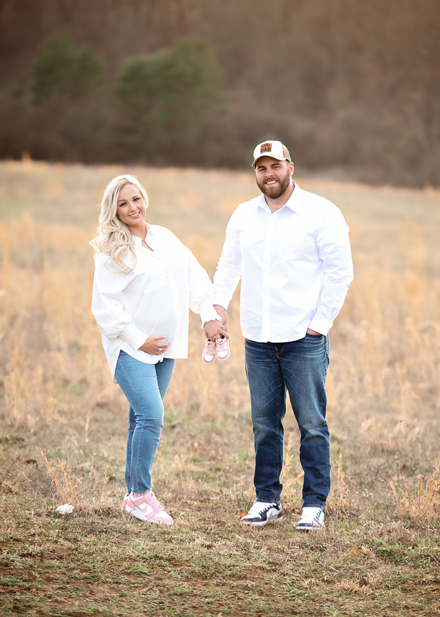 Casual lifestyle photography session showing feet and legs of couple in a rustic field setting.