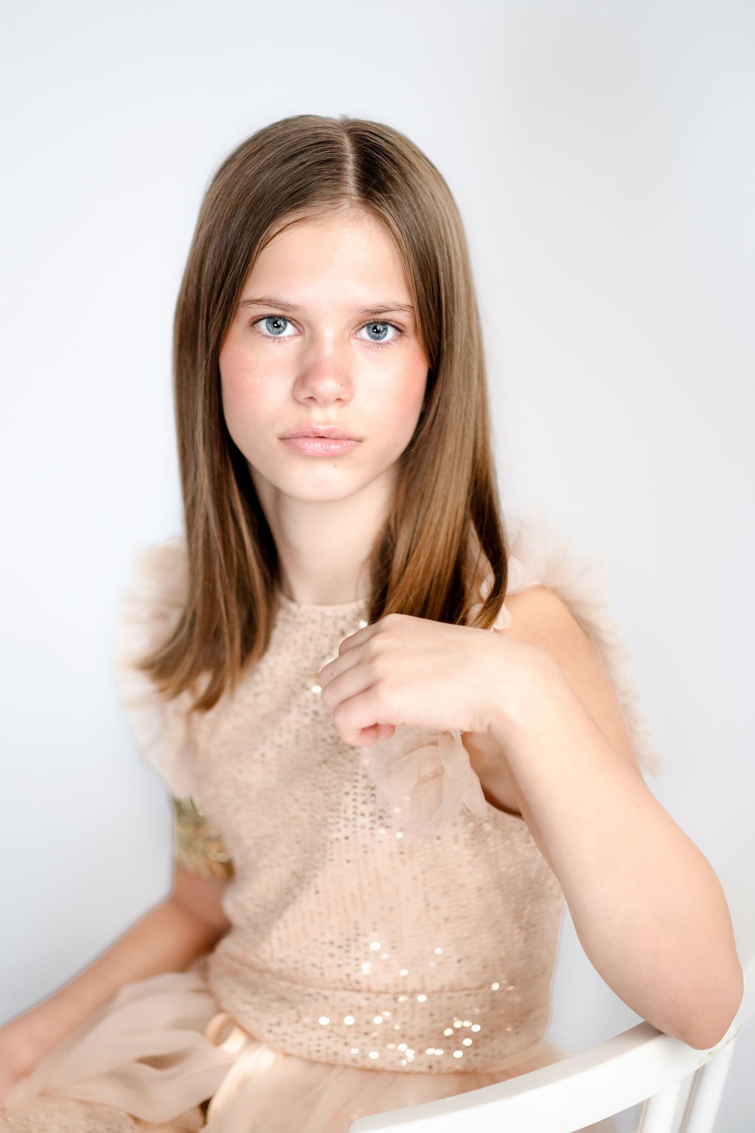 Fashion portraits featuring sparkly beige sequin top against white backdrop.