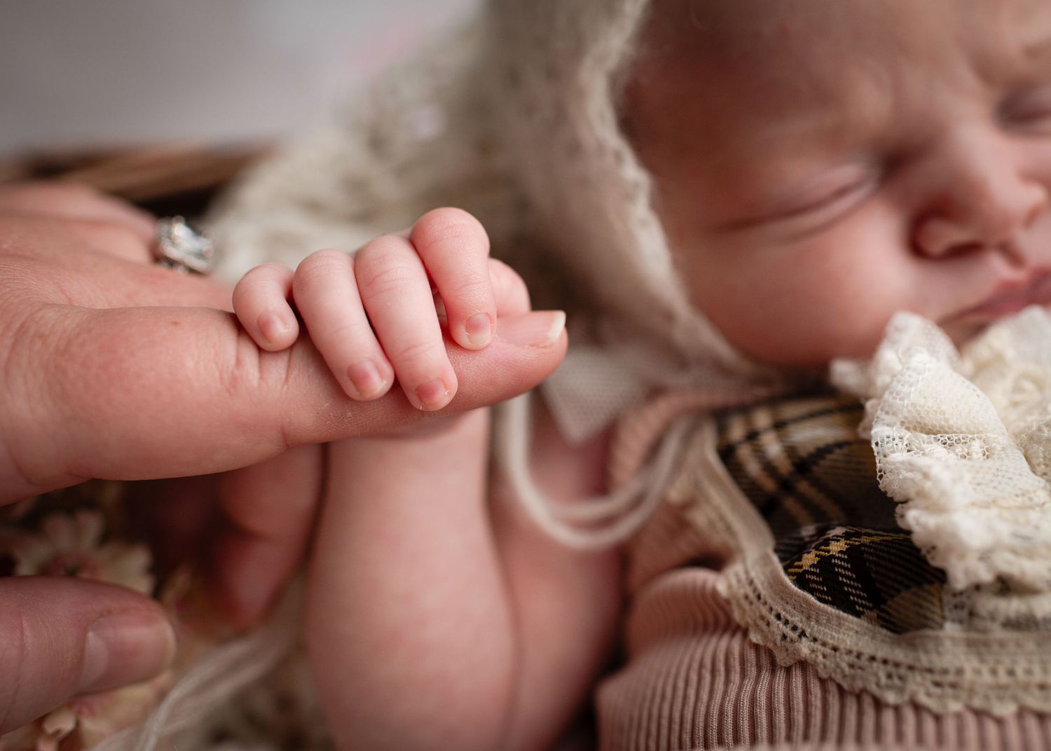 A series of close-up photos showing tender moments with a baby's tiny hands and fingers.