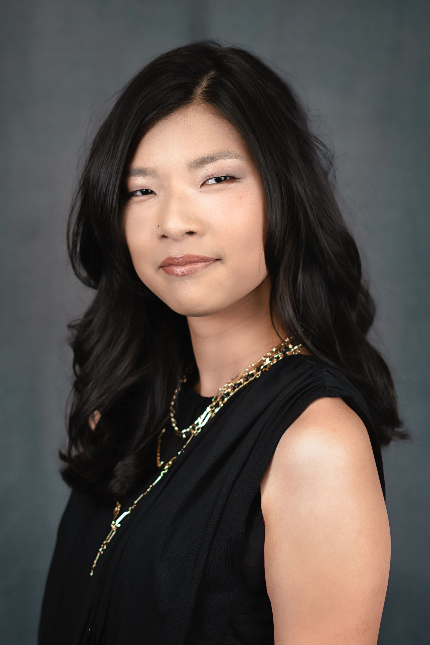 Glamour portraits featuring a person in black sleeveless top with gold necklace.