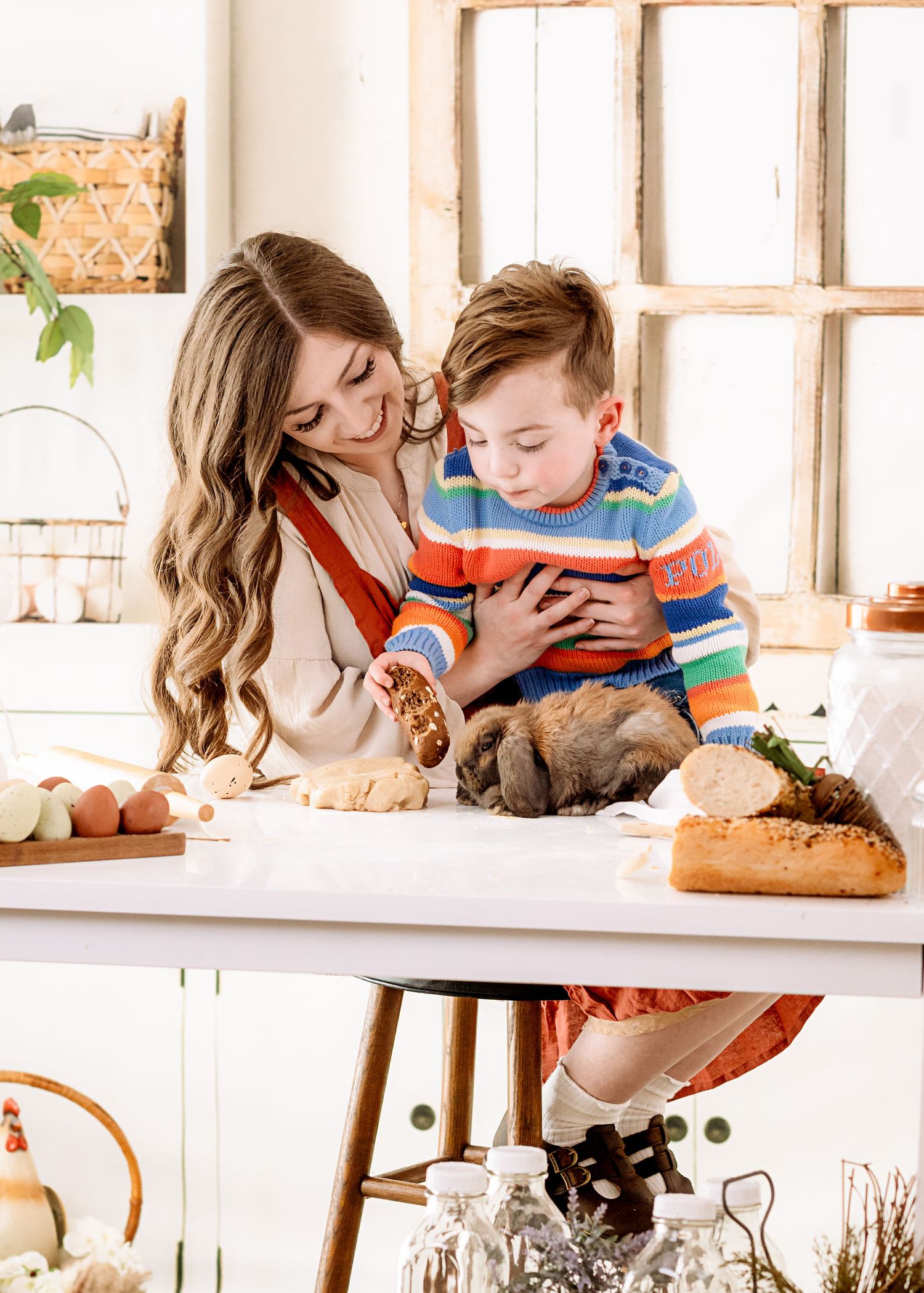 A tender family moment captured in a bright, modern kitchen with natural light streaming through windows.