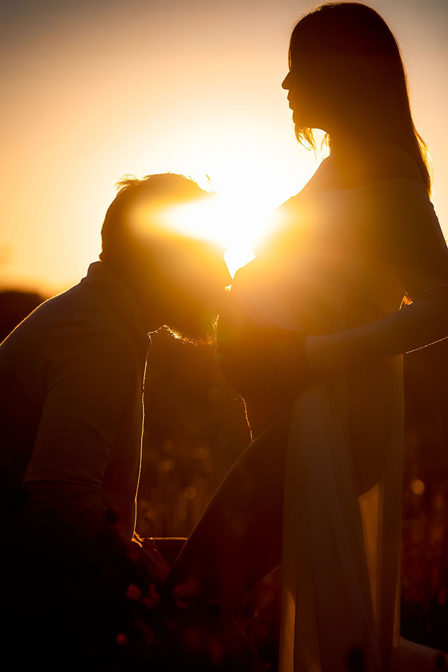 Silhouette portraits at sunset creating dramatic backlighting effects.