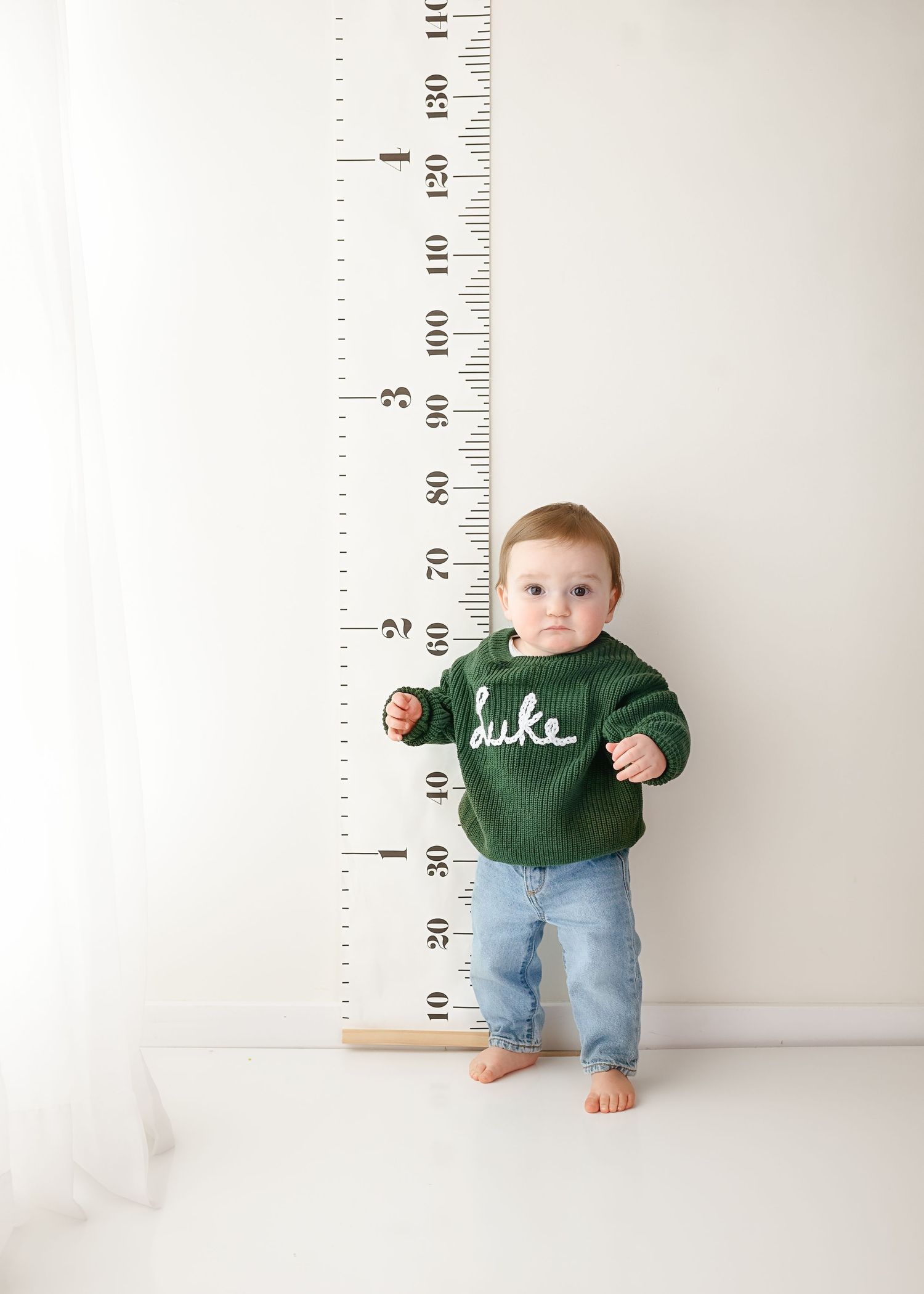 Growth chart measurement setup with green and denim styling.