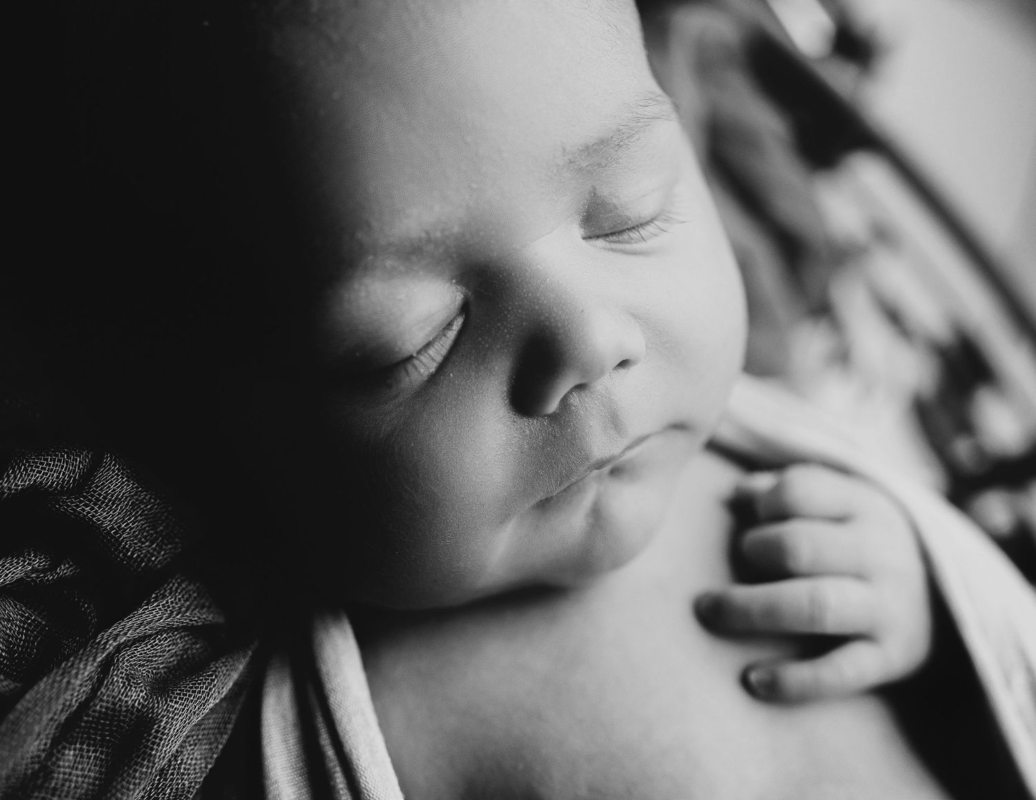 Artistic black and white close-up portraits of sleeping newborn.