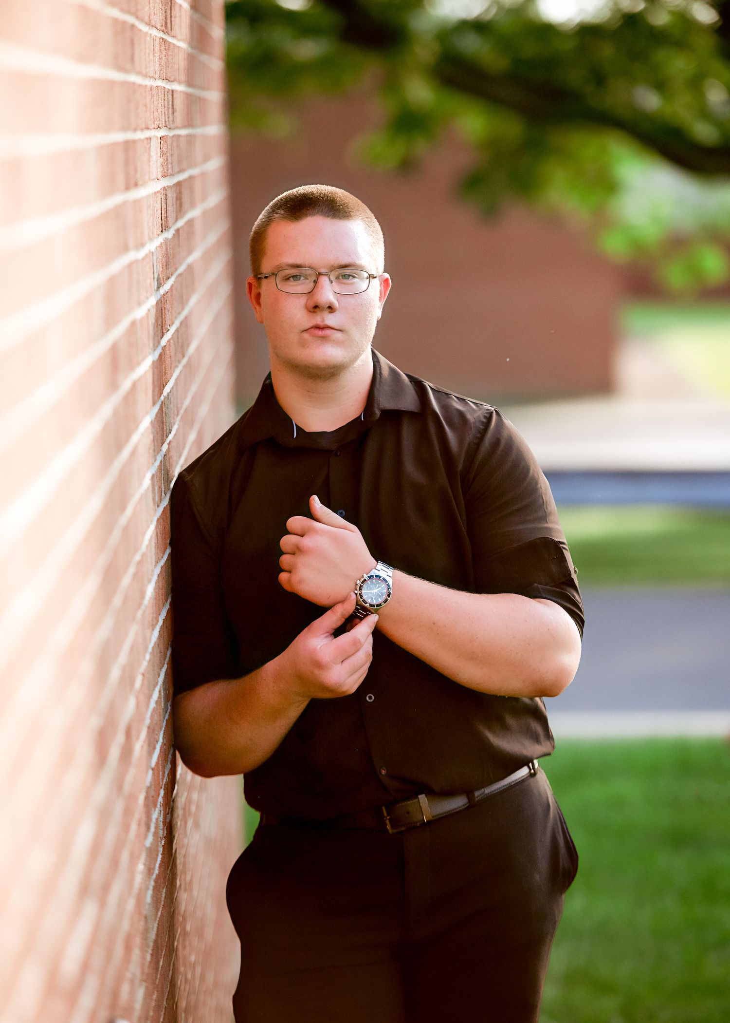 Portrait session against pink wall in black casual wear.