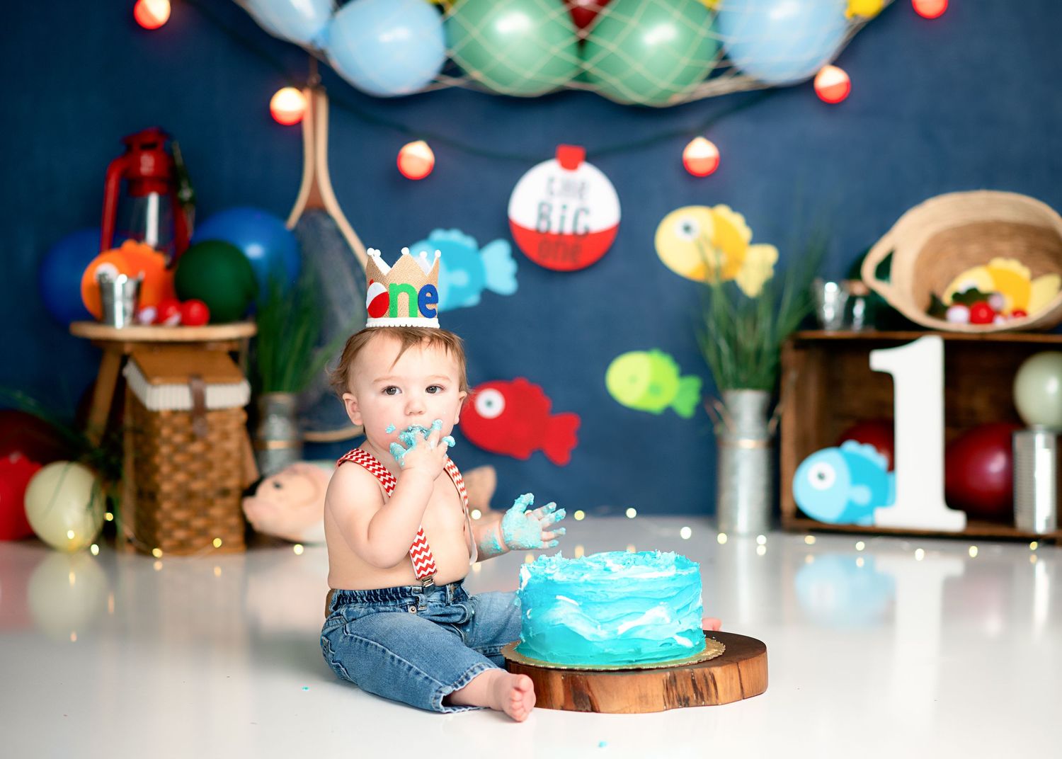 Dark blue backdrop with colorful lights and tropical party decorations.