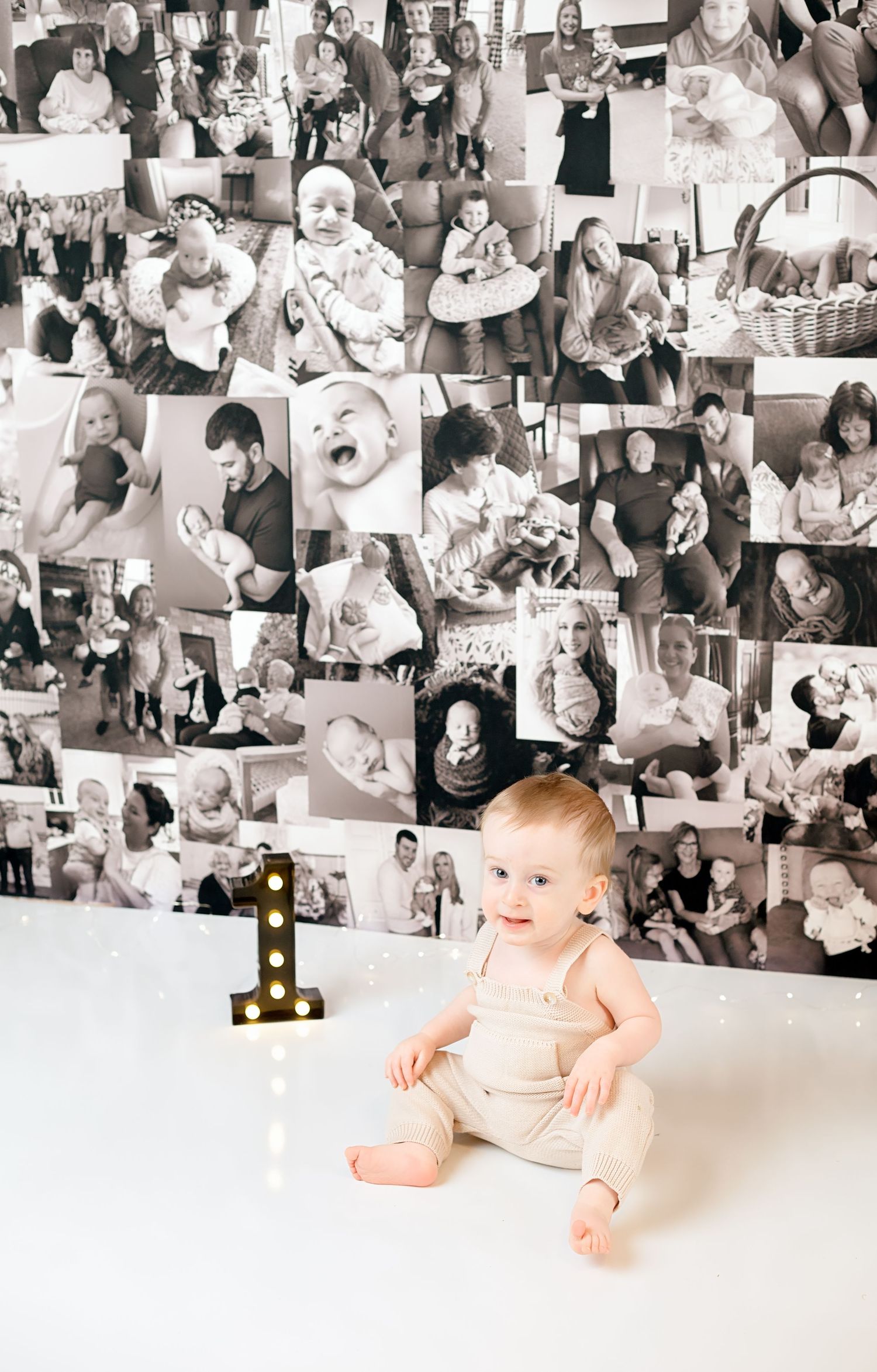 Black and white photo collage wall display with birthday celebration scene in foreground.