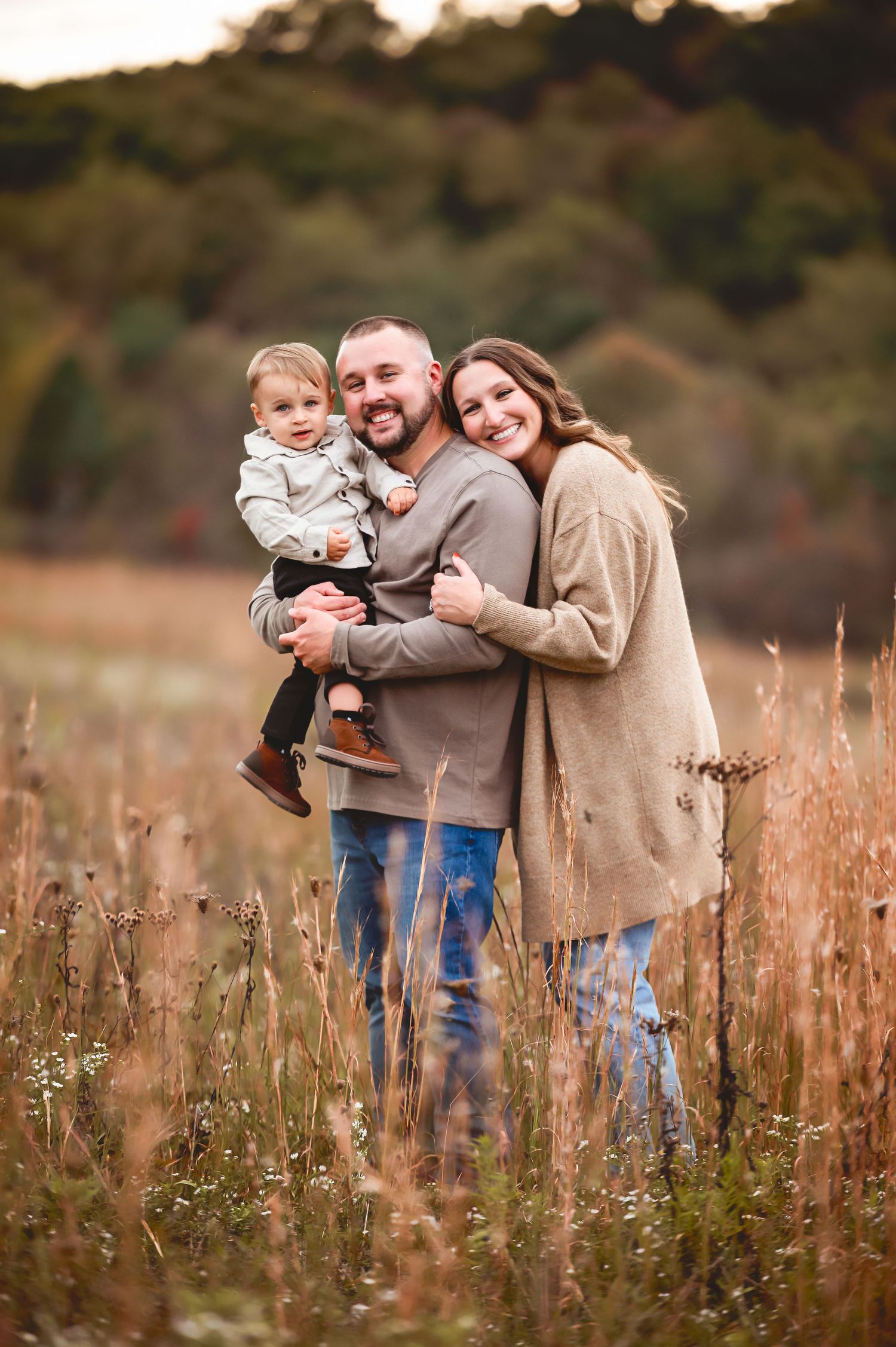 Sweet family interactions in a tall grass meadow during golden hour.