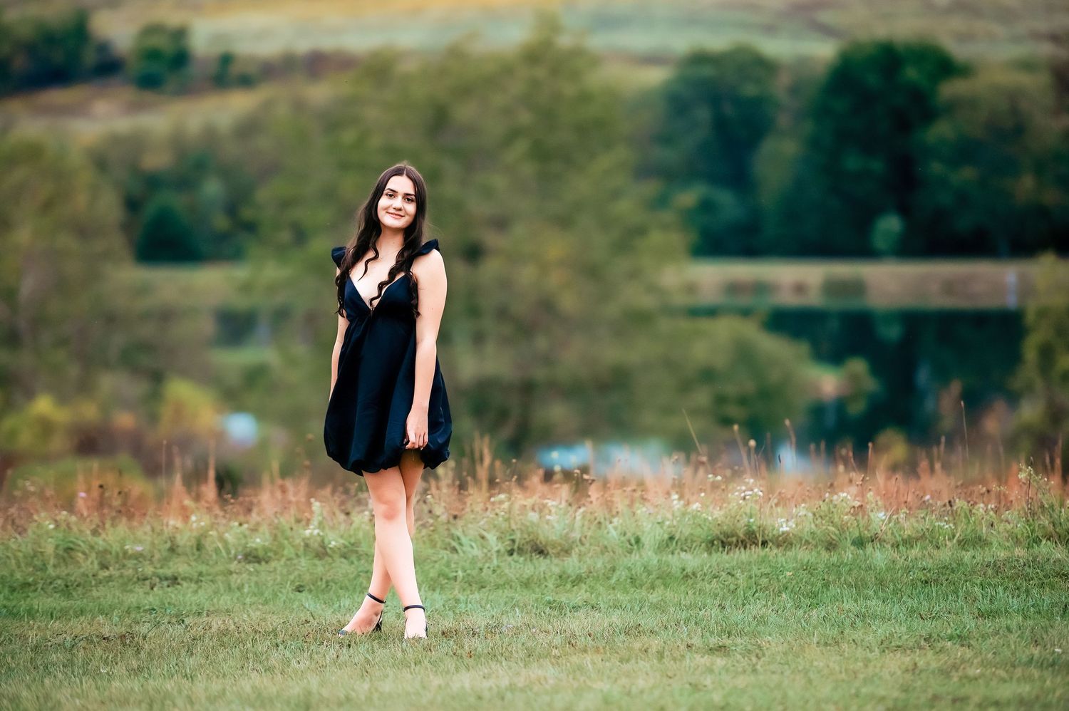 Distant shots taken in a grassy field with rolling hills in the background.