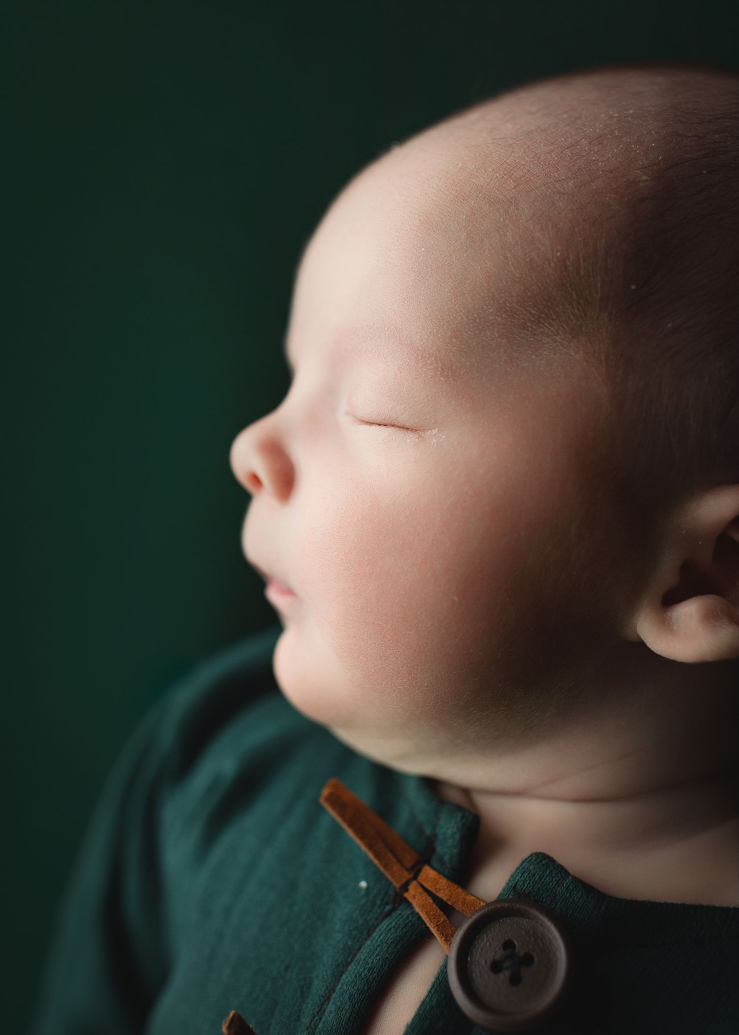 A close-up profile view shows a wooden clothespin gently gripping someone's nose against a dark green background.