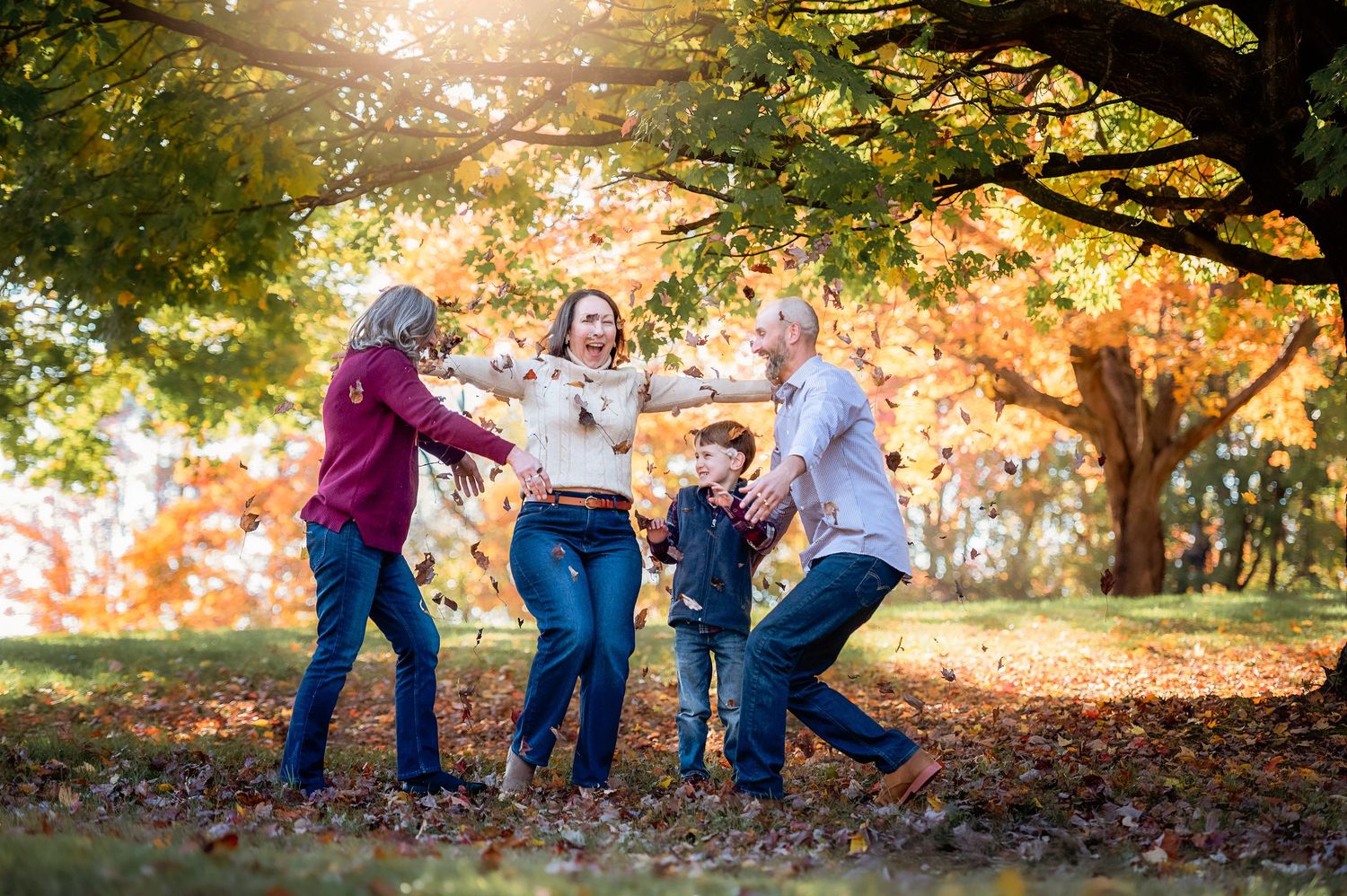 Playful moments captured in a park with autumn foliage and sunlit trees.