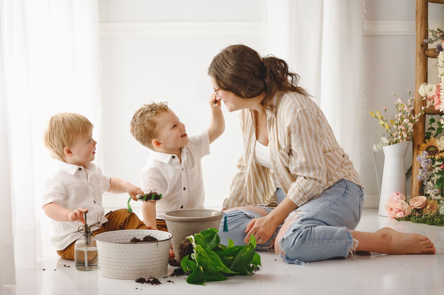 Children playing together on white floor in bright sunlit room with minimalist decor.
