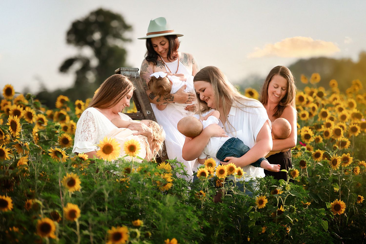 Family gathering in a blooming sunflower field at sunset.