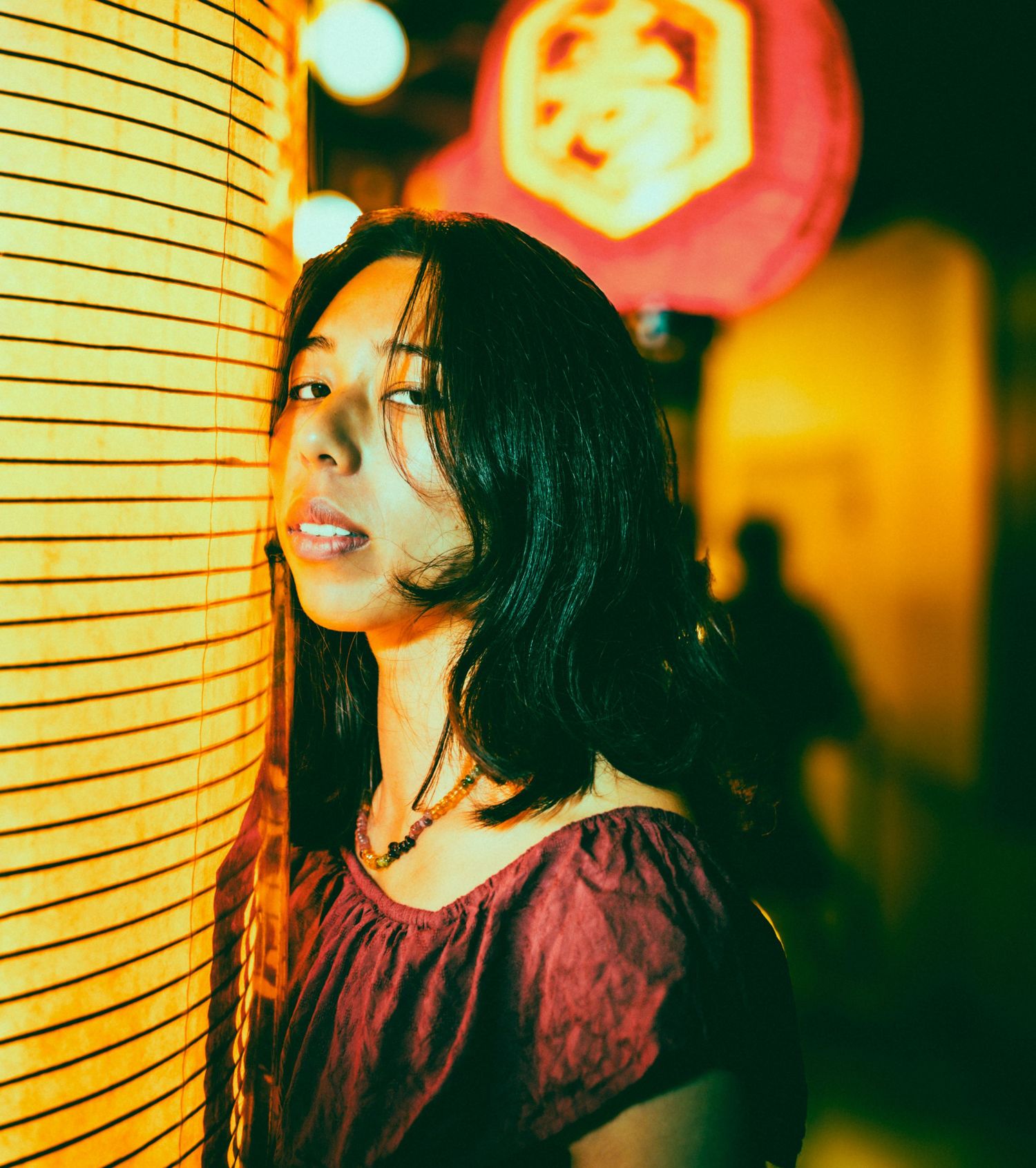 Red paper lanterns illuminate a nighttime scene with warm ambient lighting.