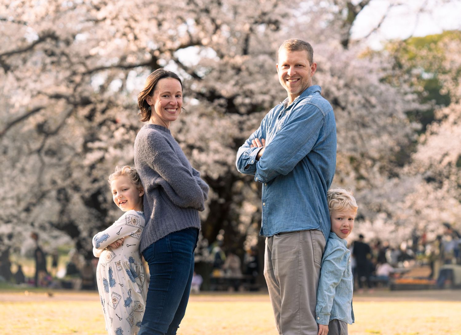 Casual family photo with cherry blossoms in full bloom.