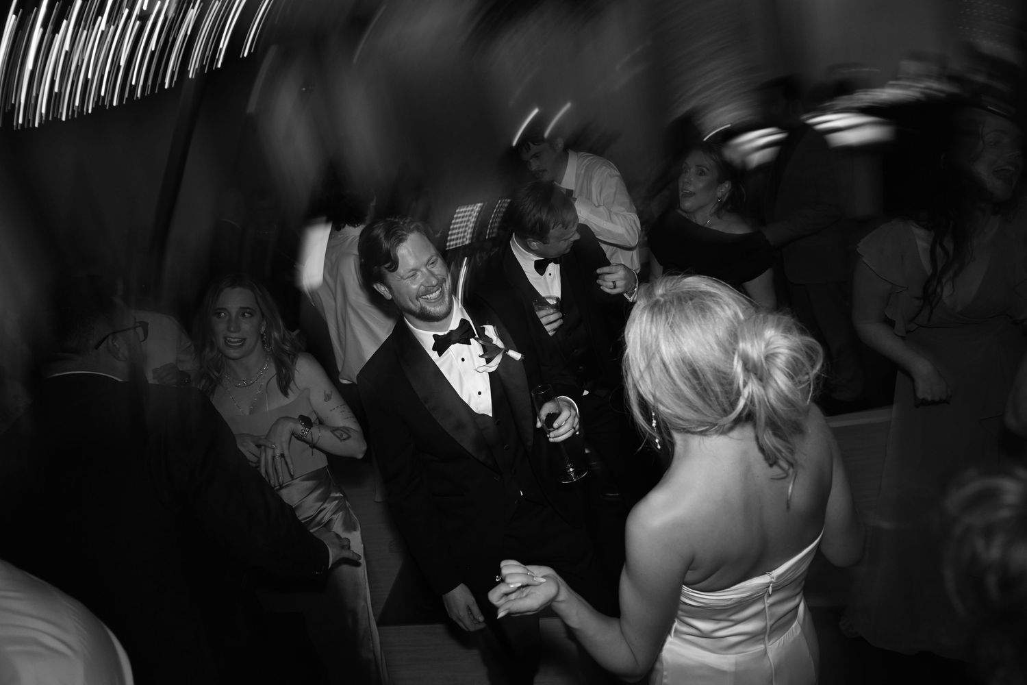 A group of people dancing at a formal event.