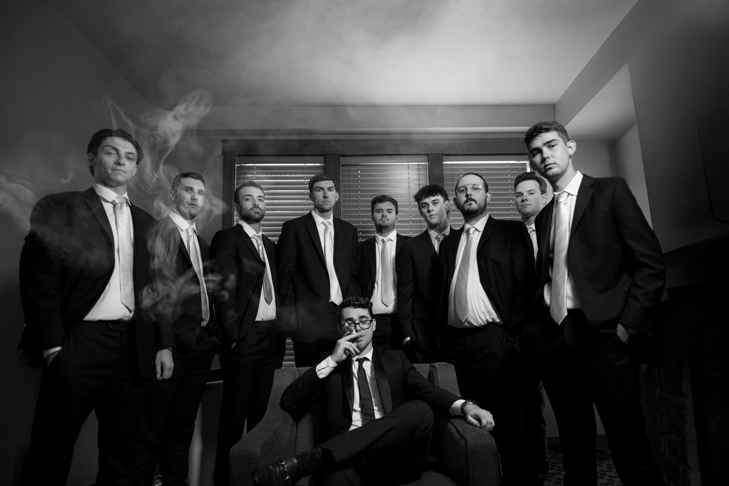 A black and white image of a group of men in suits posing for a photograph.