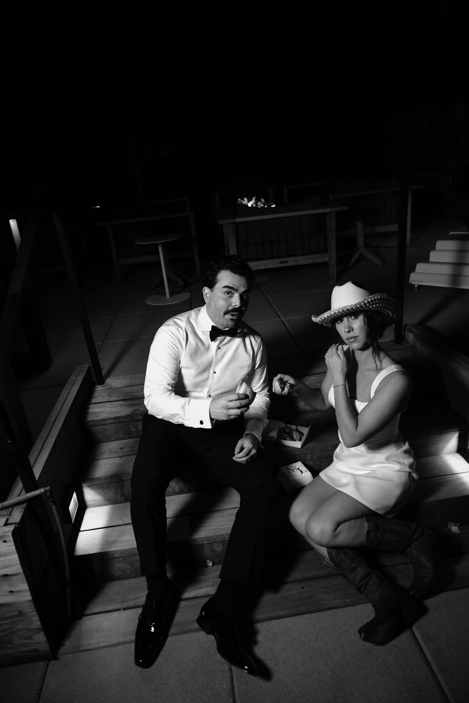 A bride and groom sitting together at their wedding reception.