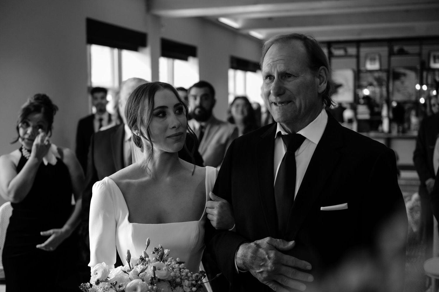 A bride and groom posing for a portrait at their wedding reception.