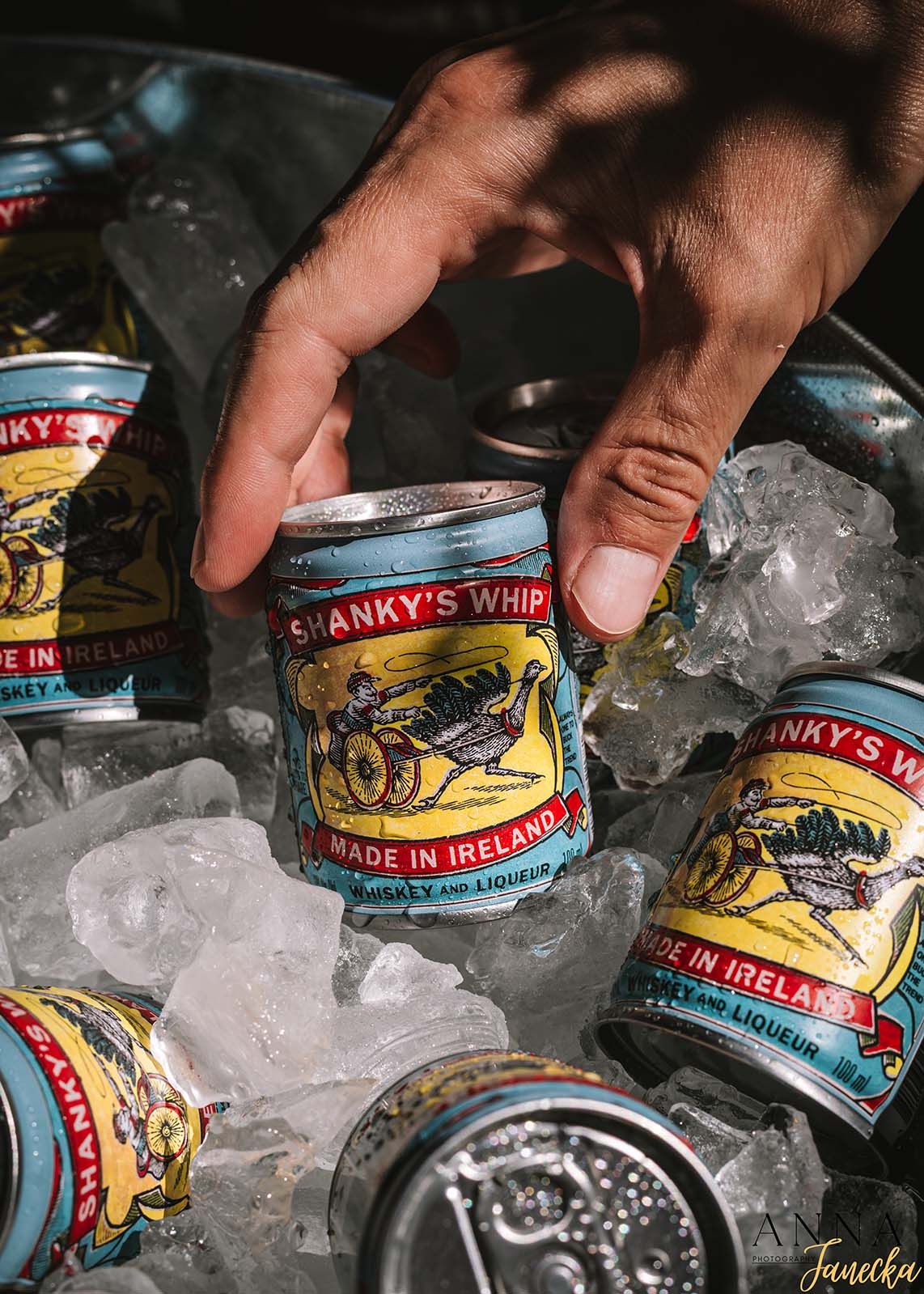 Multiple cans of sardines chilling in ice bucket.