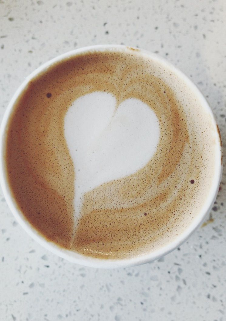 Sequence showing heart-shaped latte art forming in coffee cup.