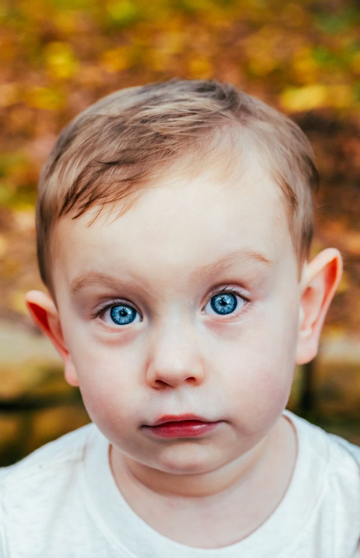 Close-up portrait shot capturing bright blue eyes and innocent expression.