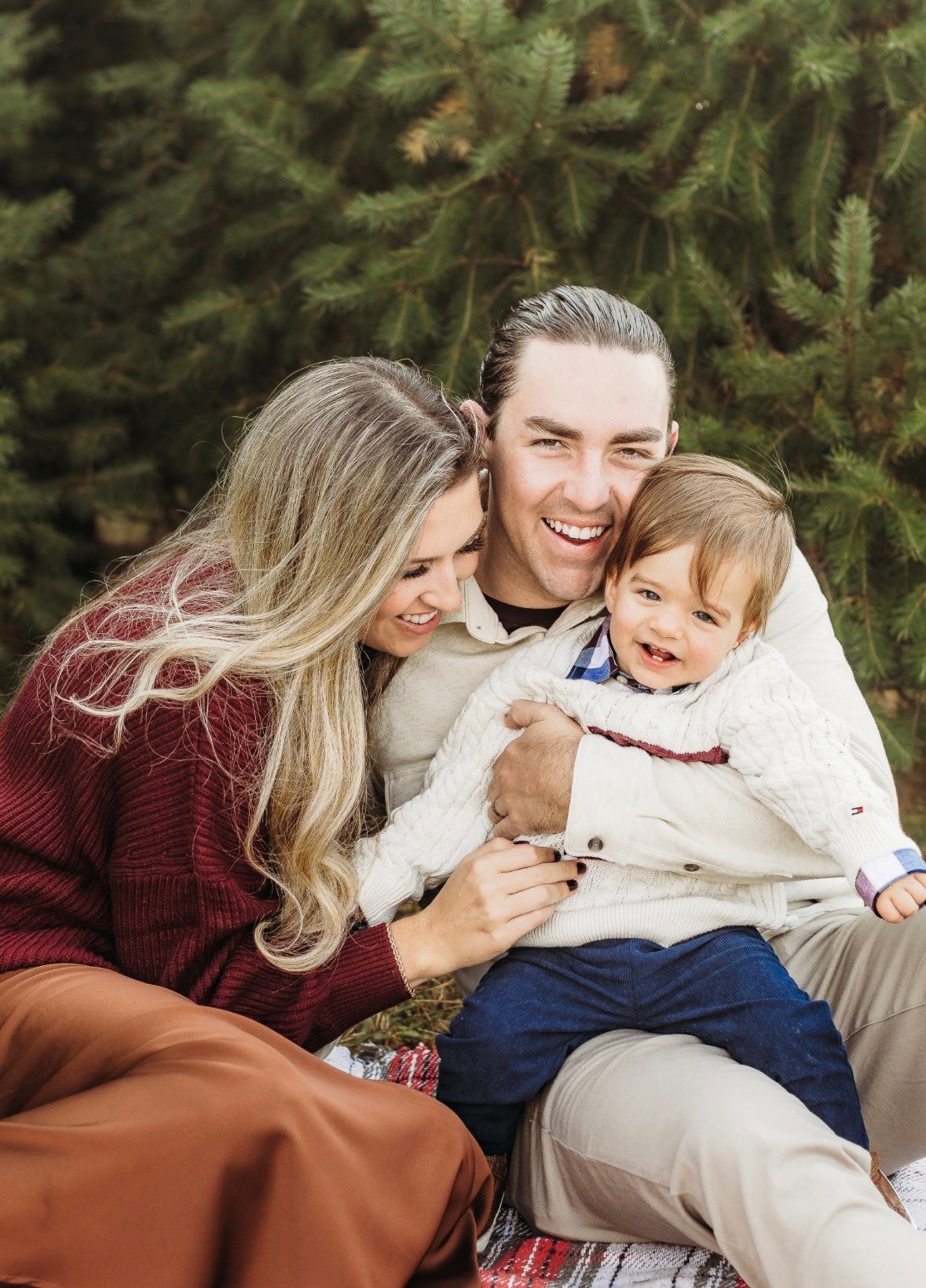 Family cuddling during a Christmas tree farm session in Sewell, NJ.