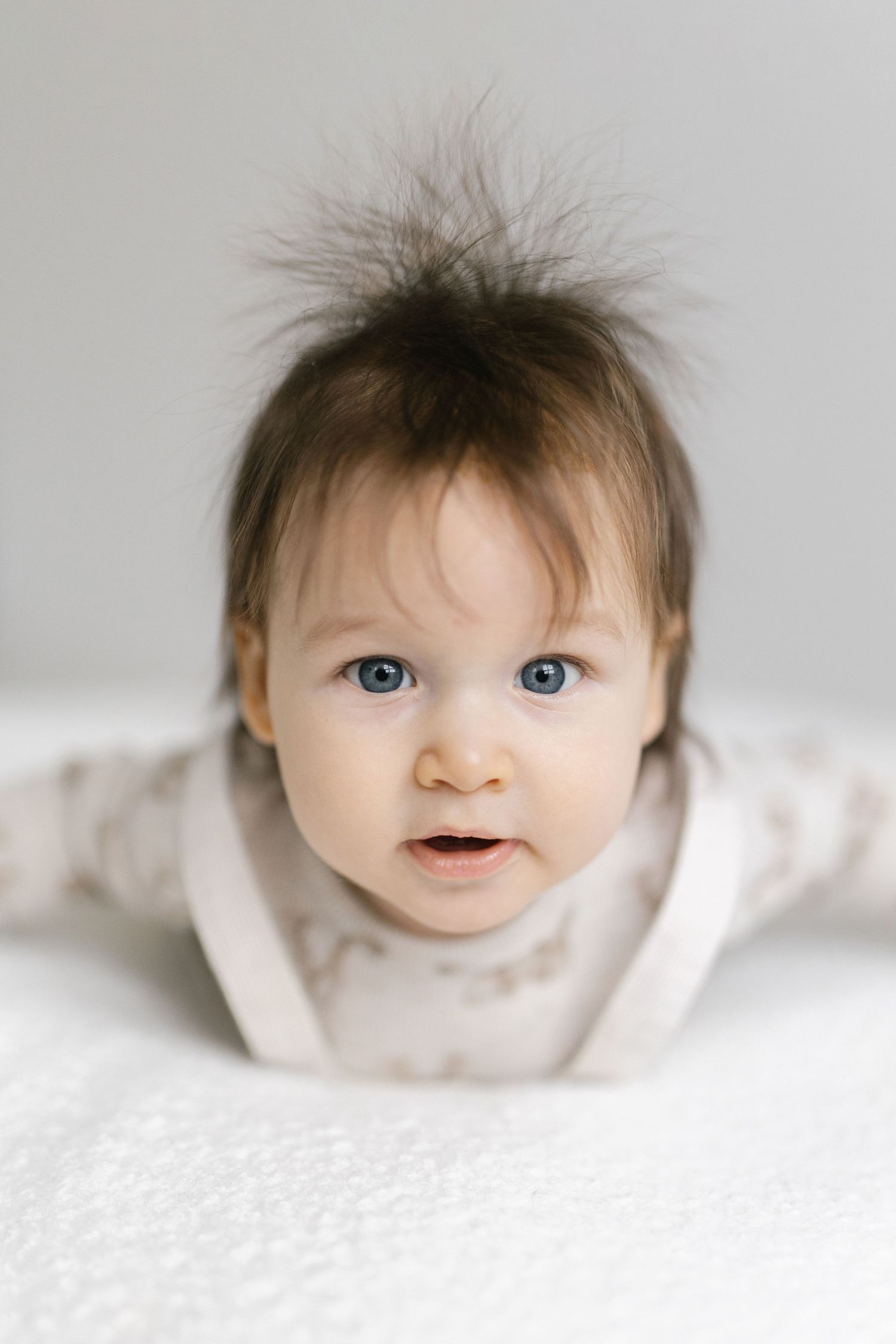 Close-up portrait sequence showing expressions against textured white background.