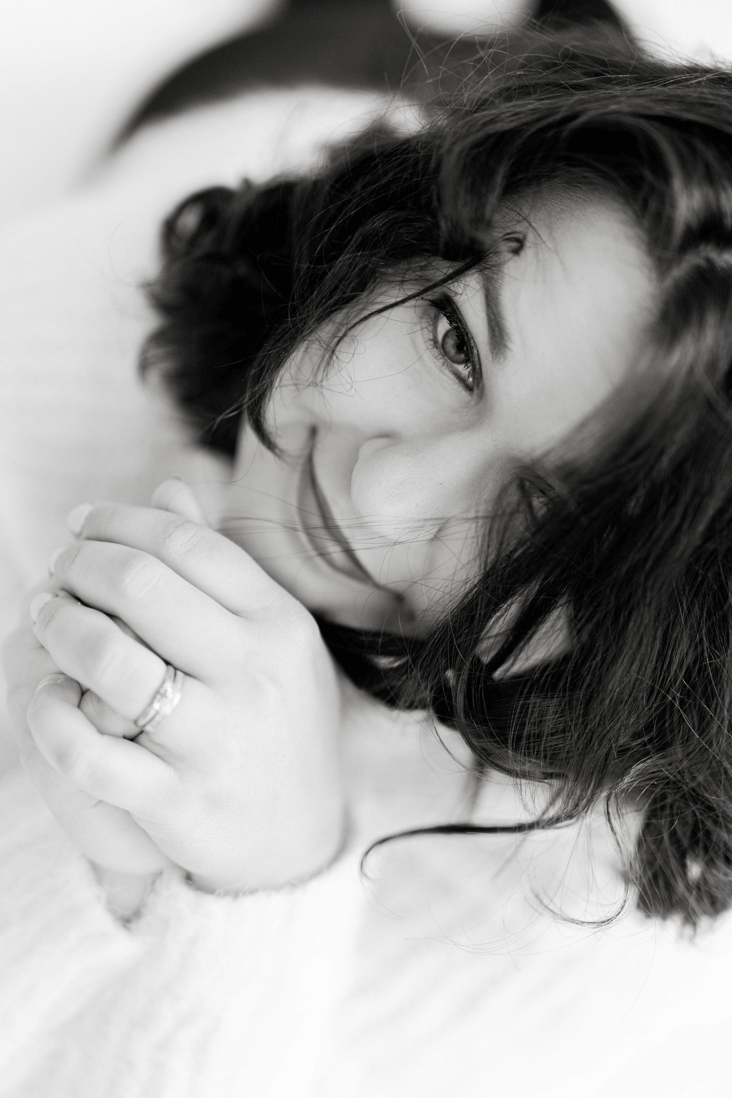 Black and white artistic portraits showing playful expressions and dark curly hair.