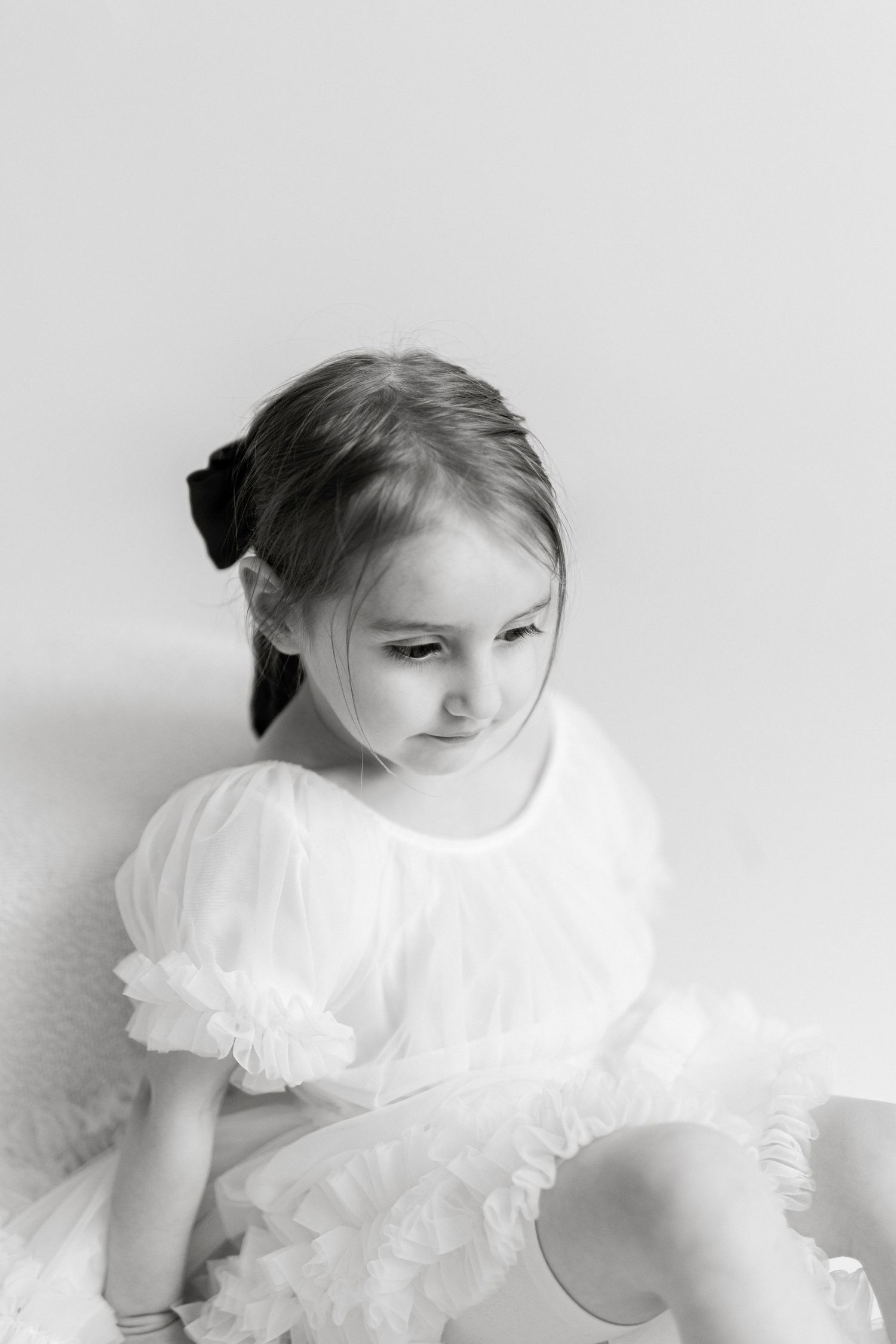 Black and white artistic portraits showing graceful poses in a ruffled dress.