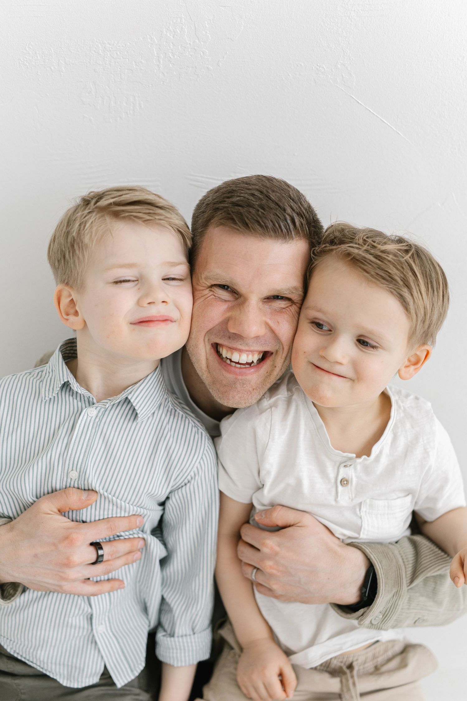 A heartwarming series of candid family photos showing joyful embraces and laughter on a light background.