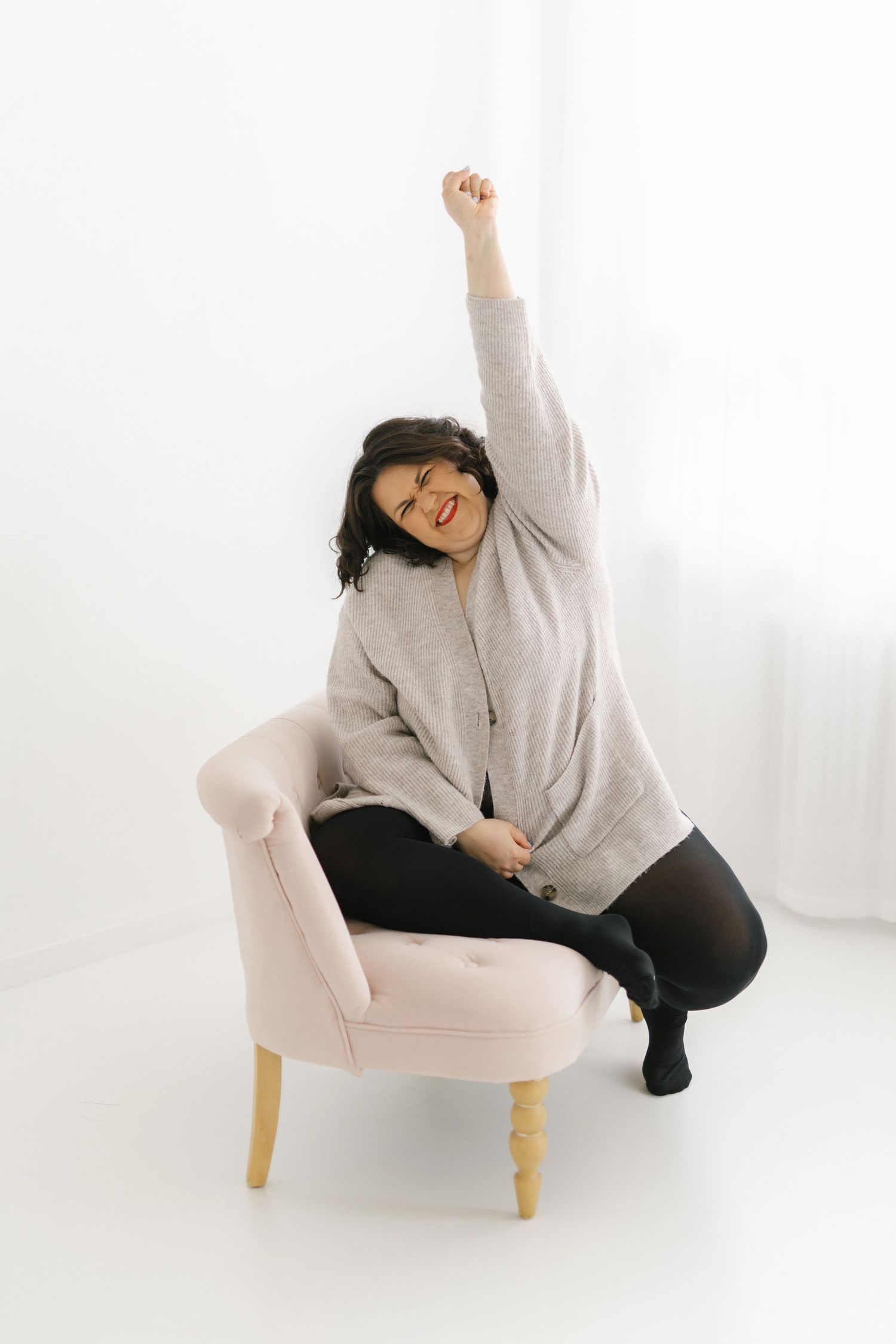 Dynamic poses on pink chair showing movement and energy in studio setting.