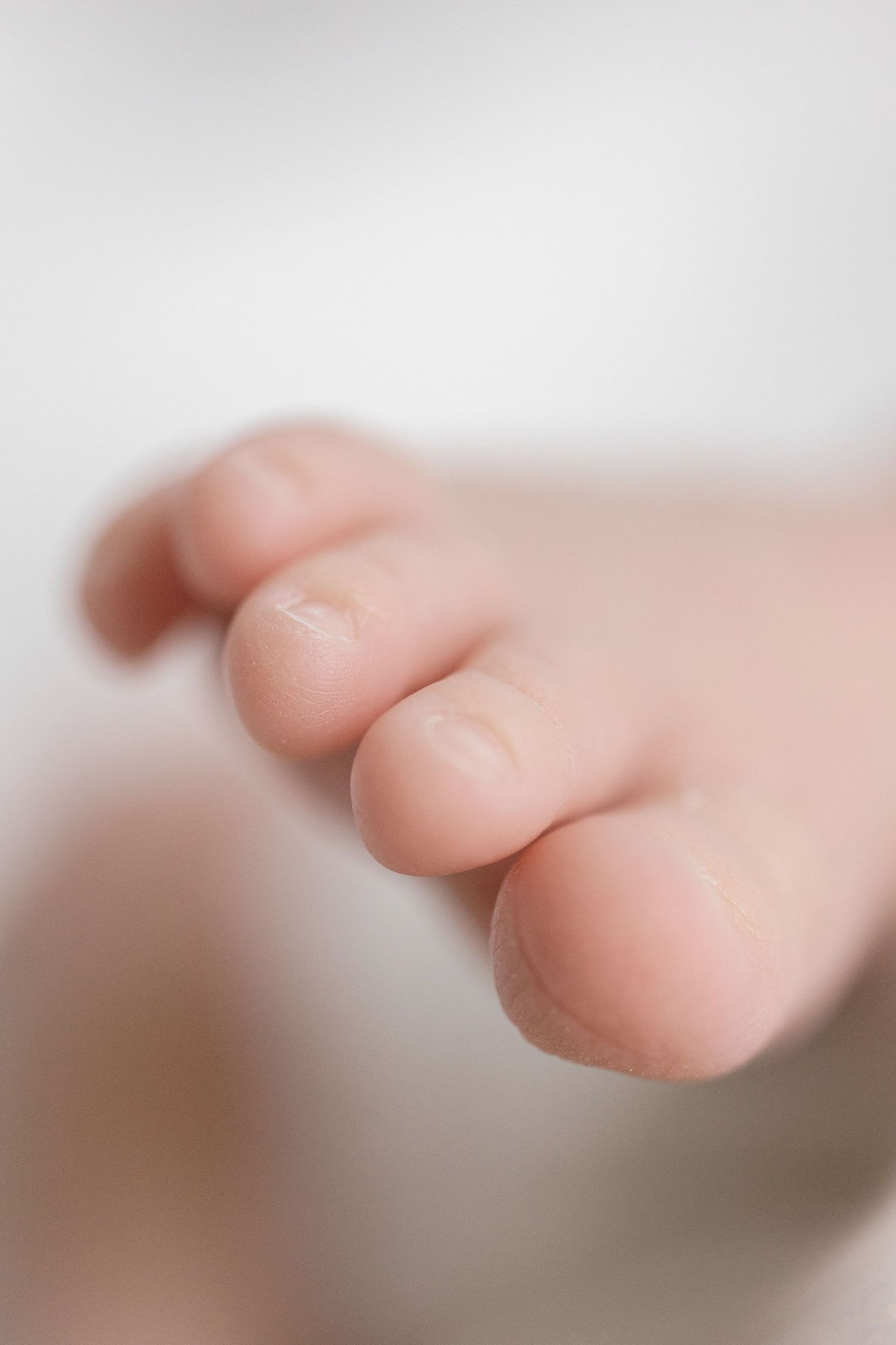 Close-up view of delicate fingers against a soft blurred background.