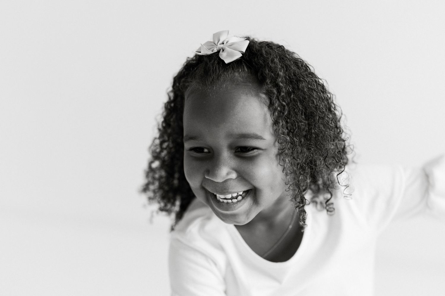 Series of joyful expressions and natural curls against a bright white background.