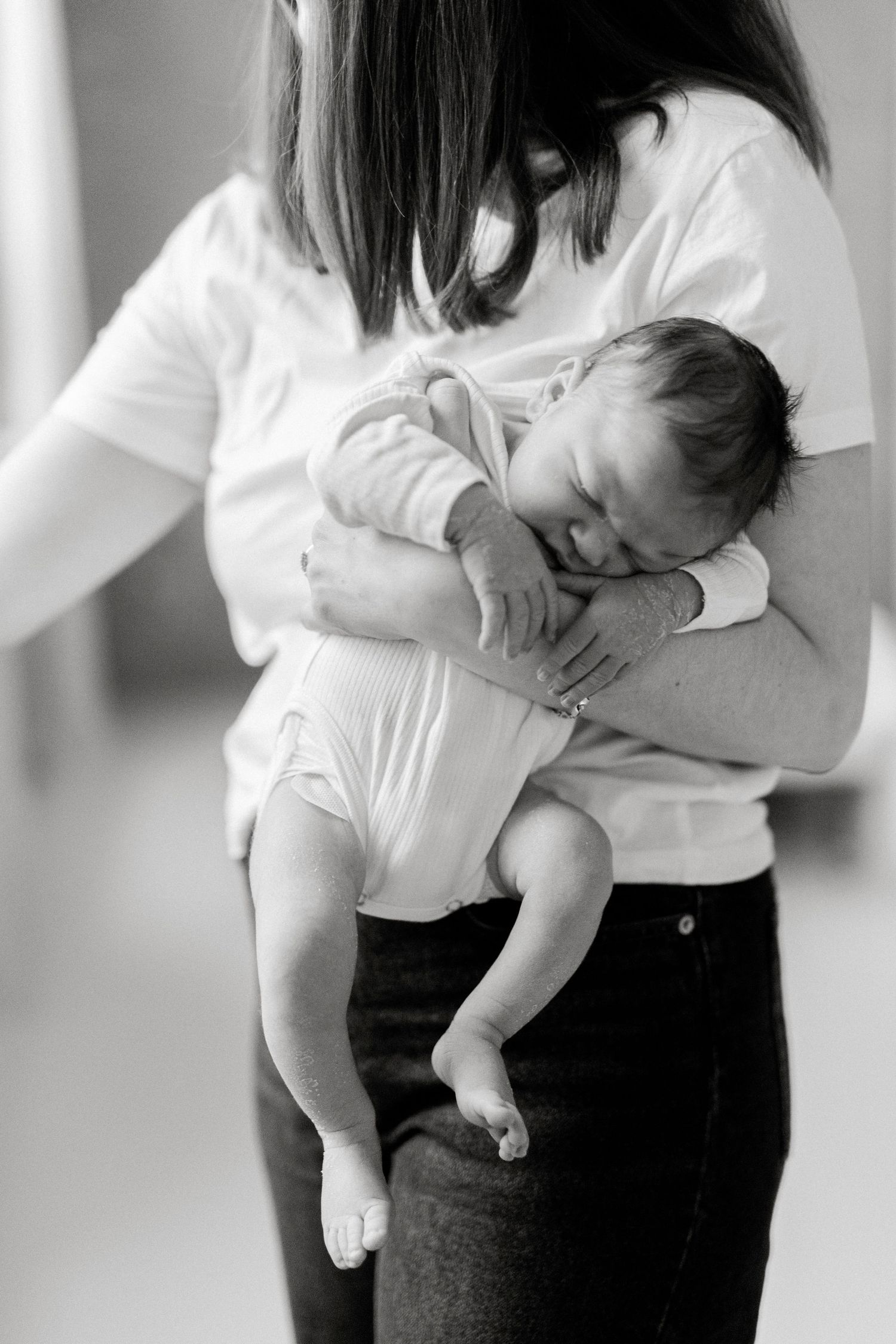 Series showing tender moments between parent and infant in white clothing.