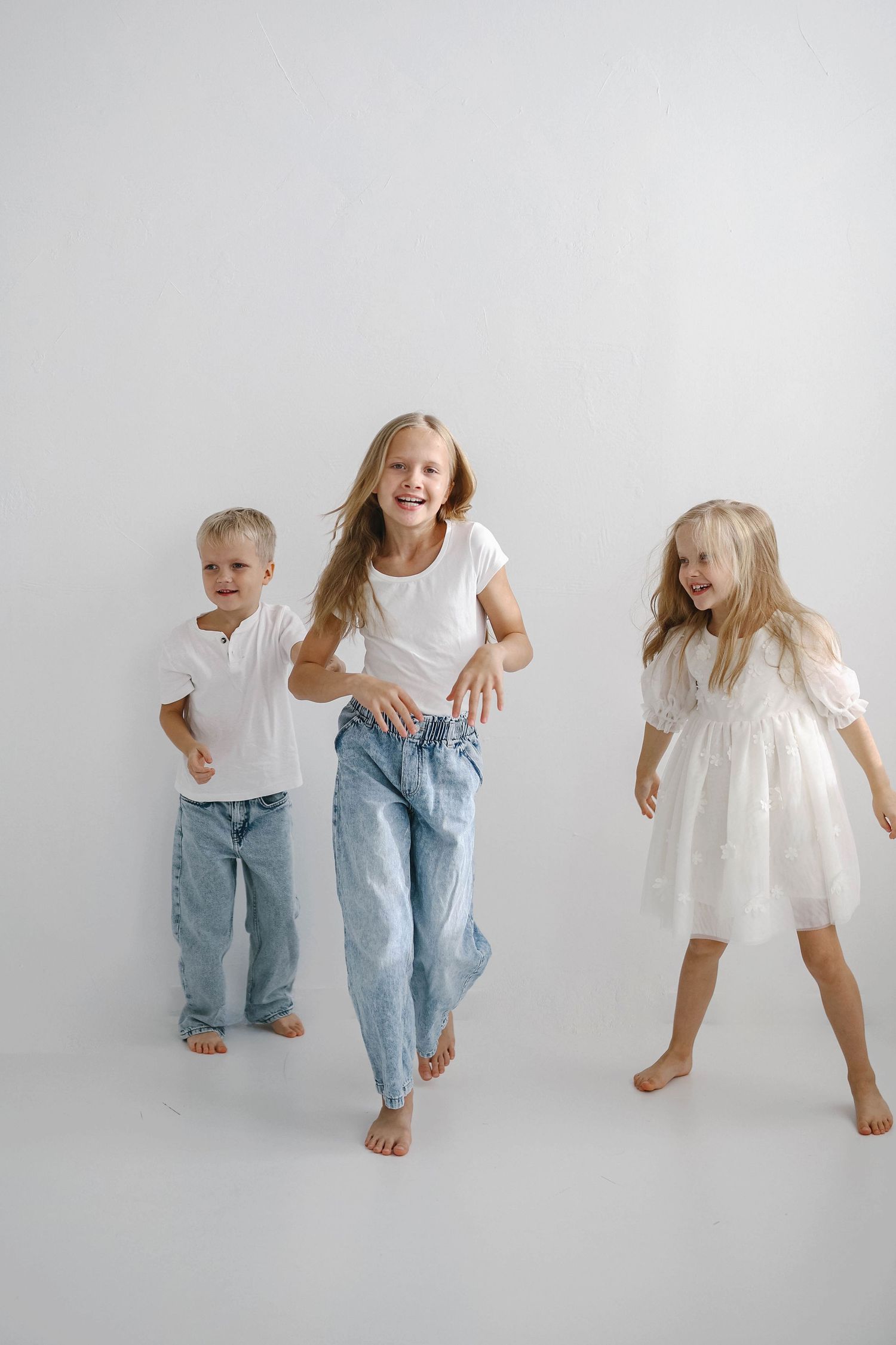 Candid family photos showing energetic dance poses in casual attire against white background.
