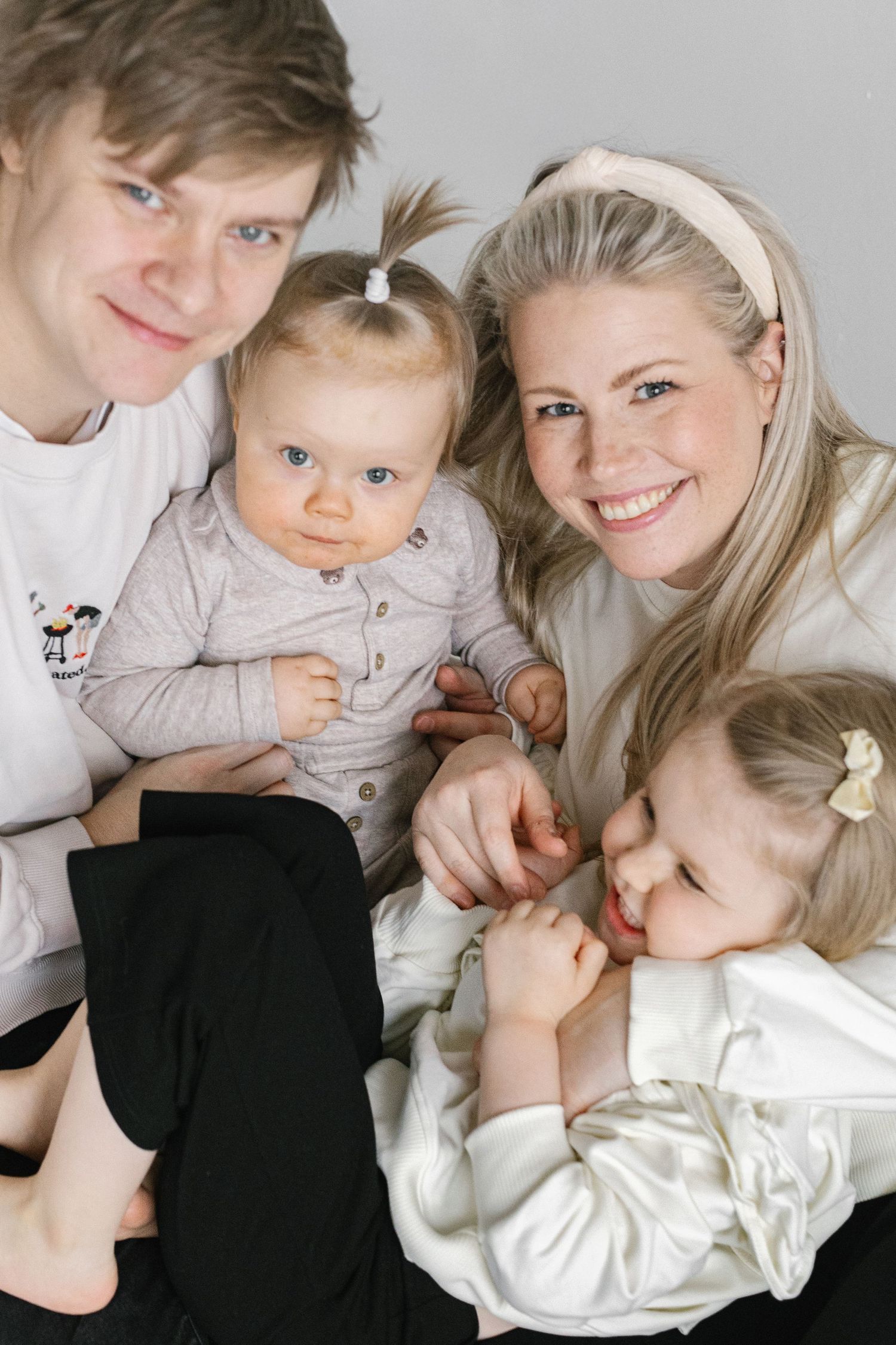 Intimate family portrait with young children in casual setting.
